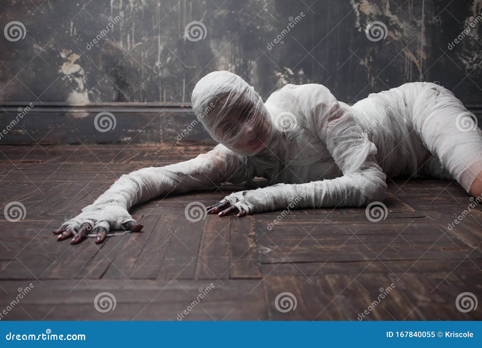 Scary Mummy Creeps On You. The Girl With The Bandage Crawling On The Floor.  Halloween Costume Stock Photo, Picture and Royalty Free Image. Image  129310486.