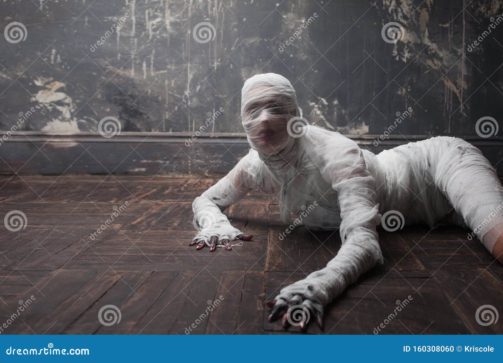 Scary Mummy Creeps On You. The Girl With The Bandage Crawling On The Floor.  Halloween Costume Stock Photo, Picture and Royalty Free Image. Image  129310290.