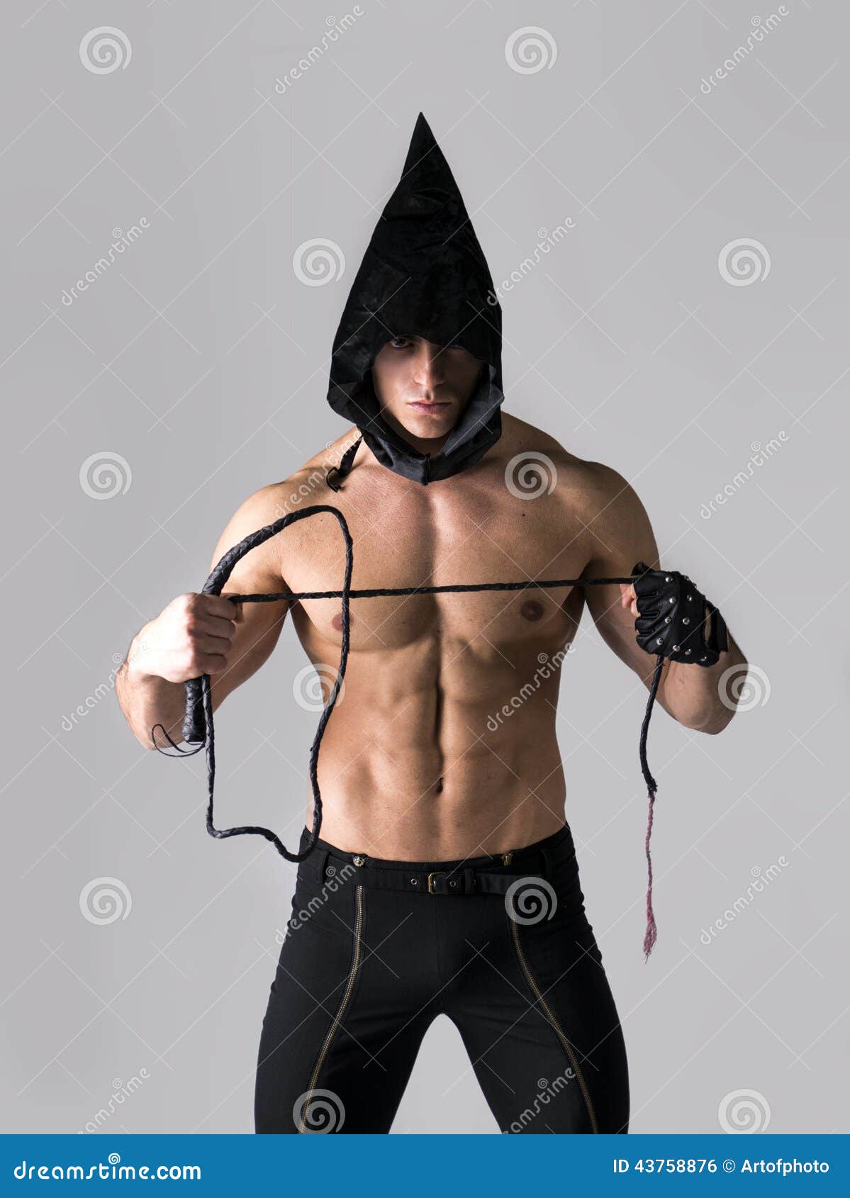 Scary Muscular Young Man with Pointed Hood on Naked Body Stock