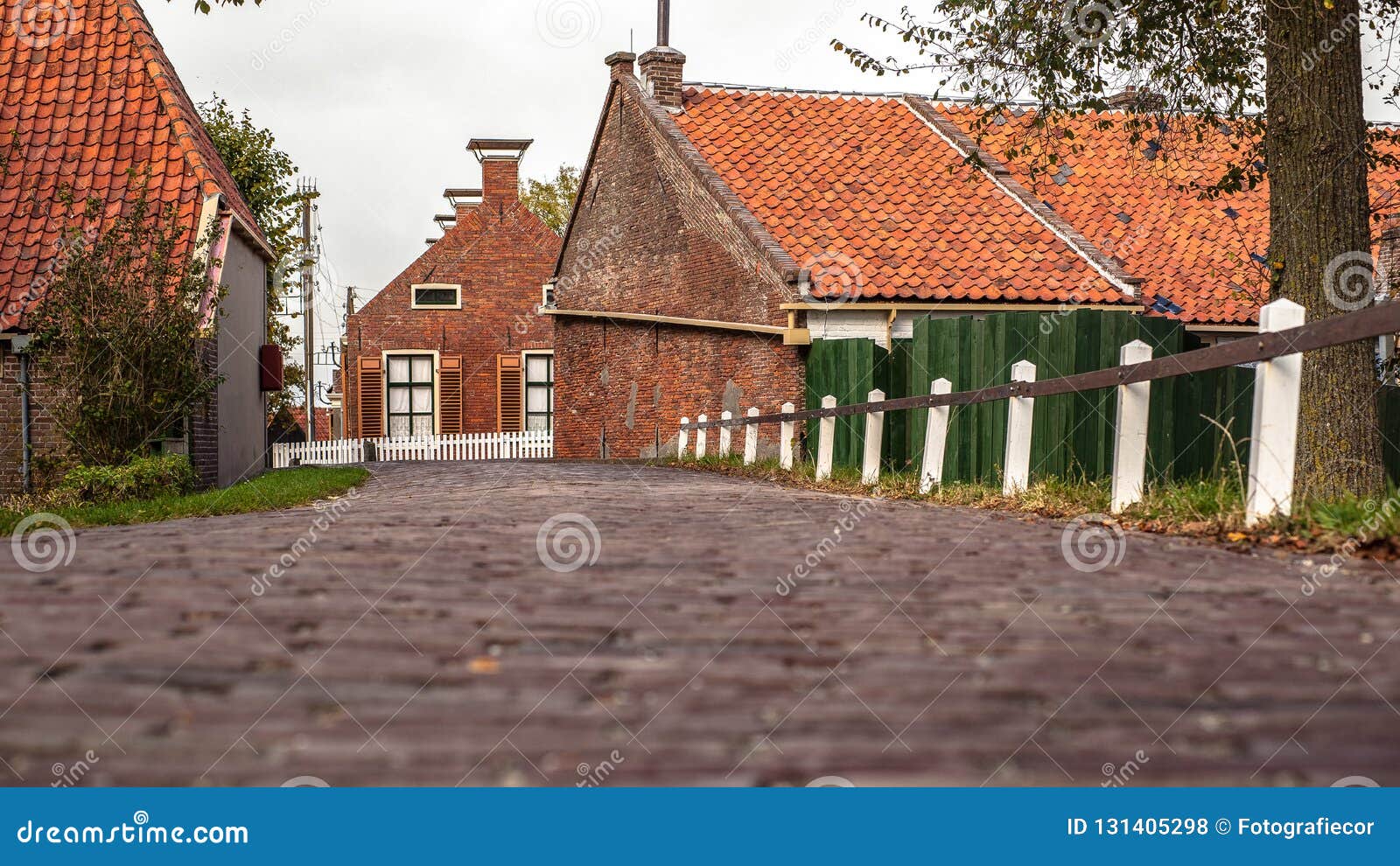 view from approach route over on traditional village with farmhouses and old pavements.