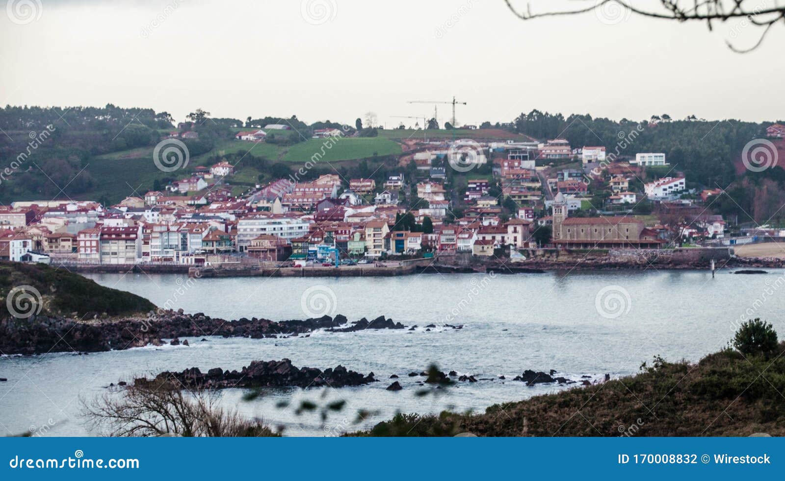 scenery of houses at the lakeshore in luanco, asturias, spain