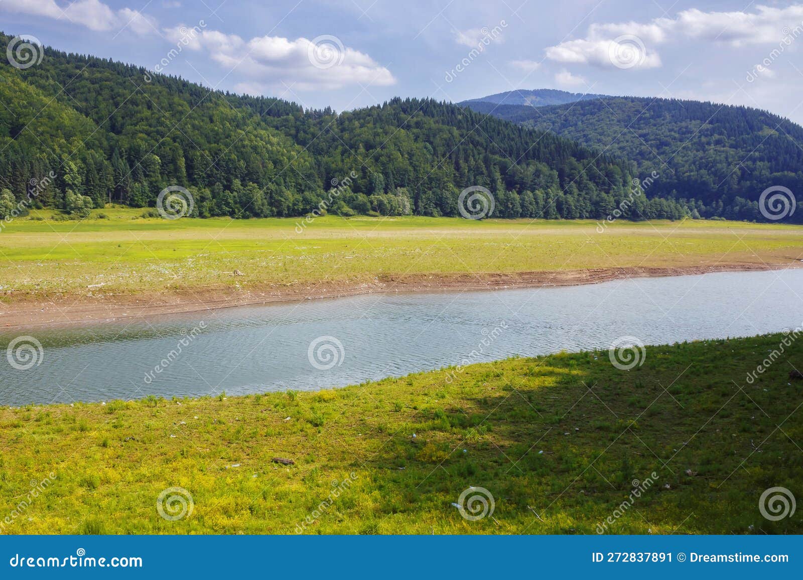 Scenery with River in Valley. Shores Polluted with Plastic and Garbage