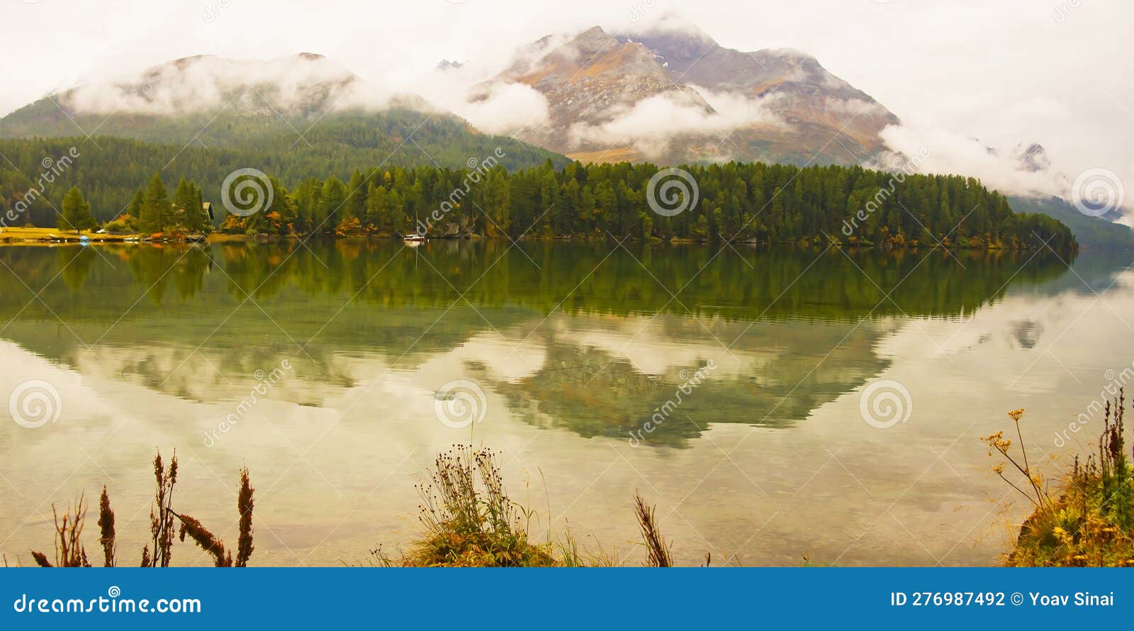 scenic landscape of low clouds of autumn and piz da la margna and lake of segl silsersee swiss