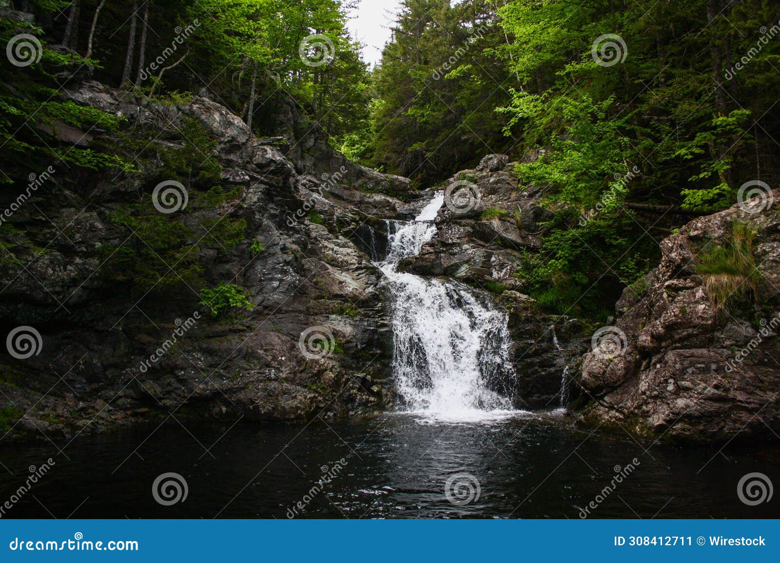 scenic memel falls in new brunswick cascading through lush forest with rocks and green foliage