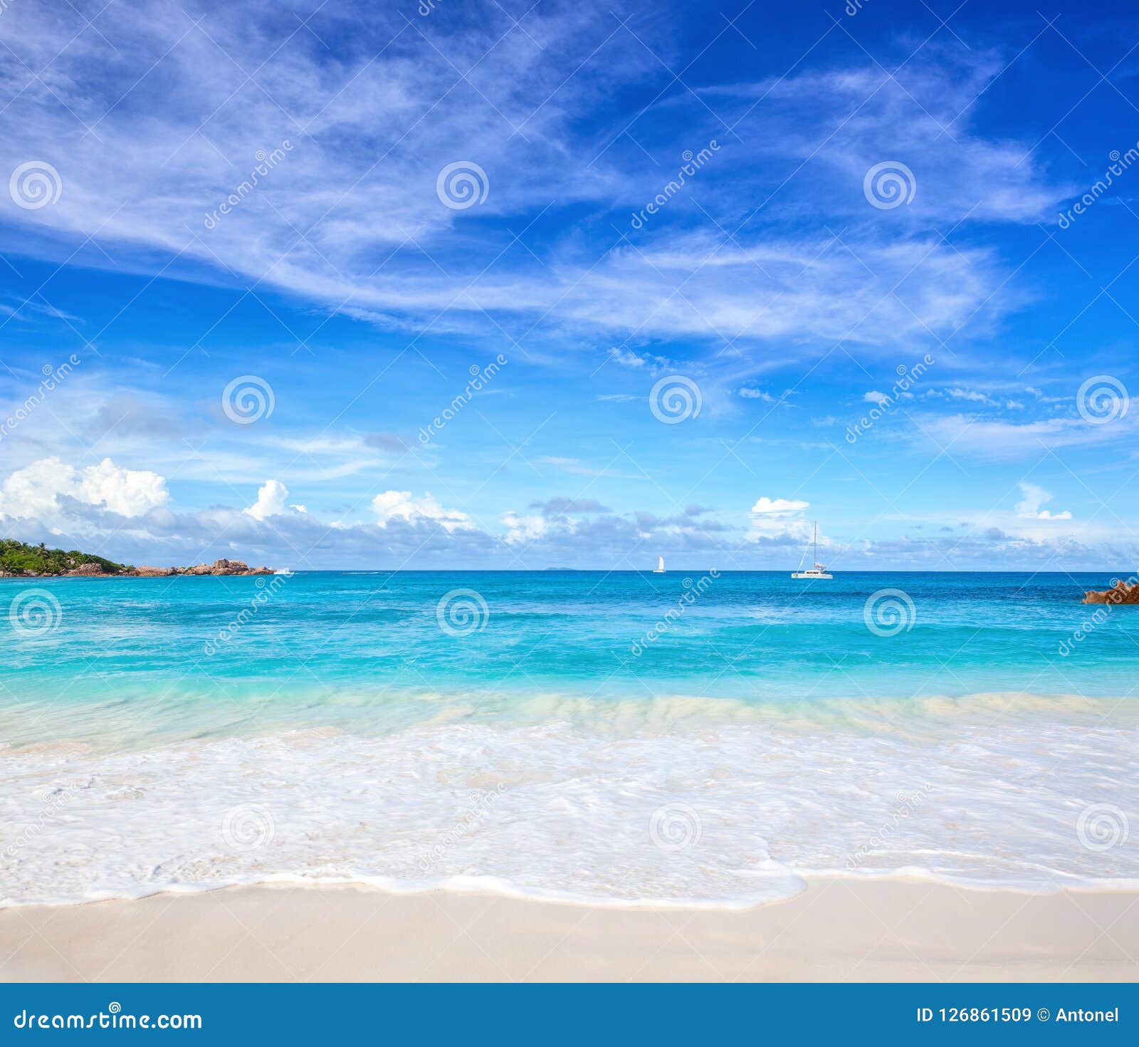scenic seascape with white sand on the beach and ocean`s turquoise water. idyllic tropical beach scene. seychelles