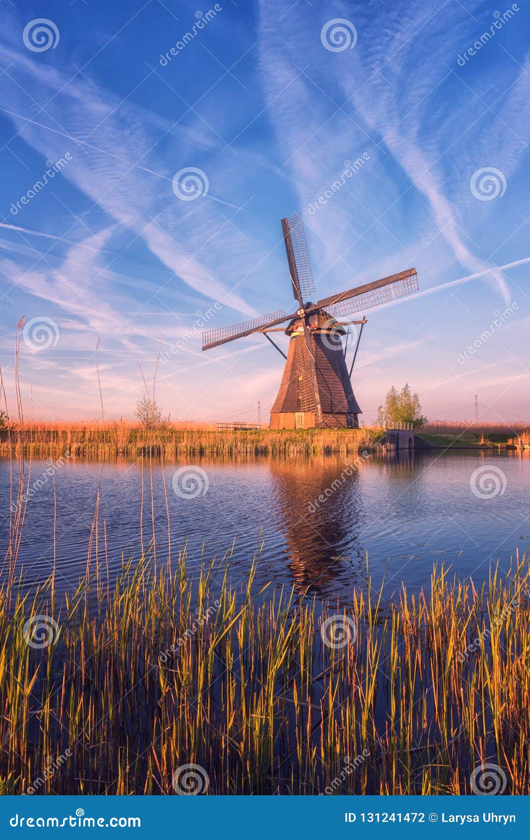 scenic sunset landscape with windmill and sky, traditional dutch village of mills kinderdijk, netherlands
