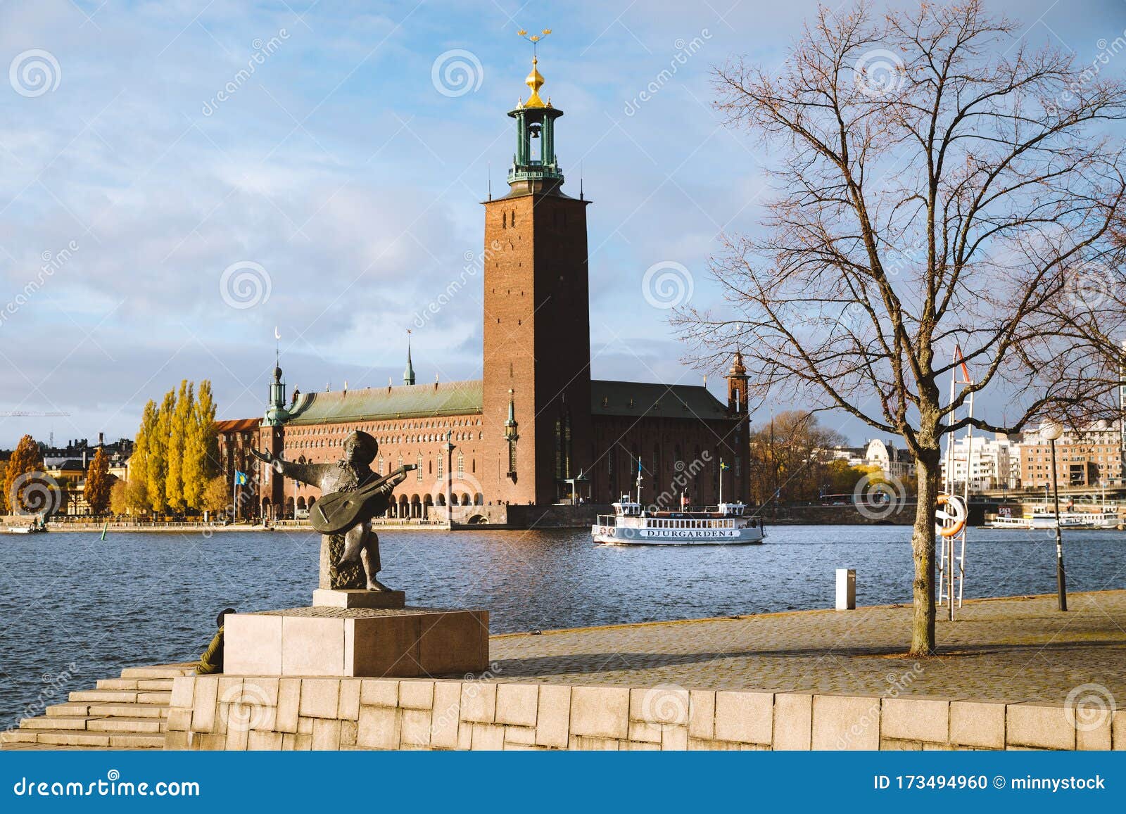 stockholm city hall with djurgarden ferry boat and evert taube statue, sweden, scandinavia