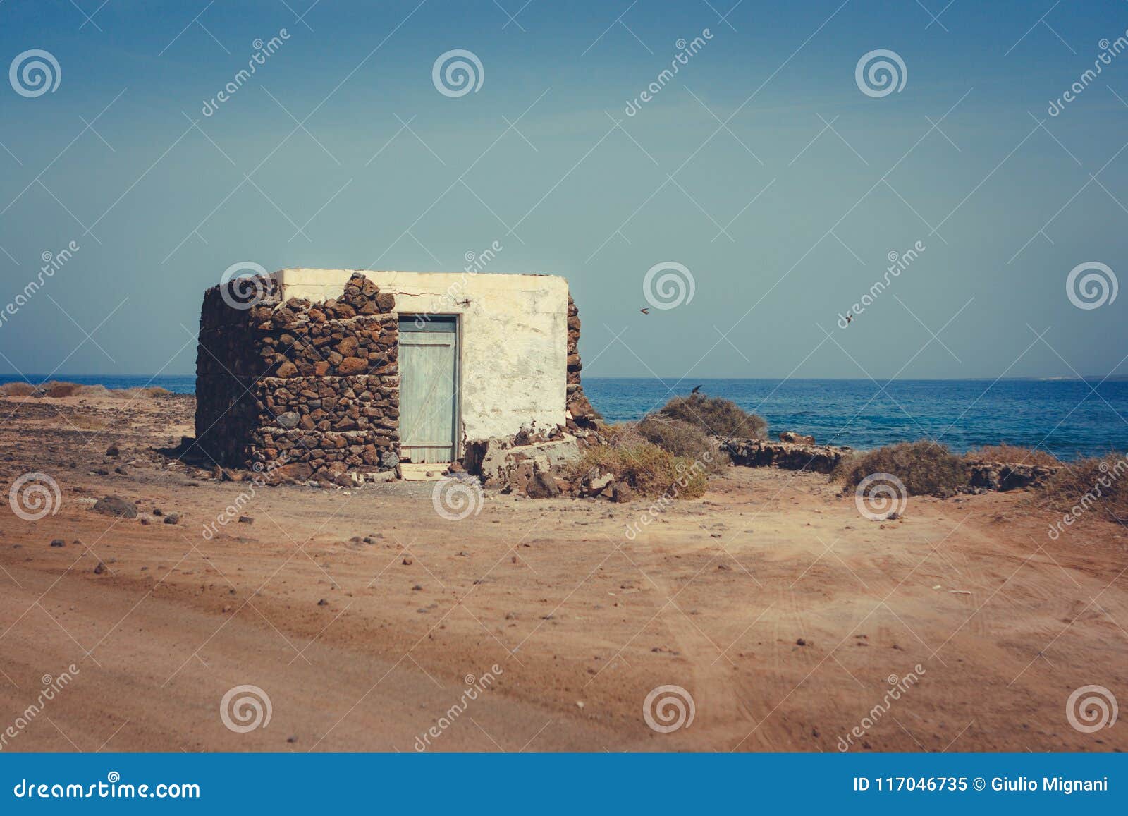 pedro barba village under a sky with clouds. ocean on the background. la graciosa, lanzarote, canary islands, spain.