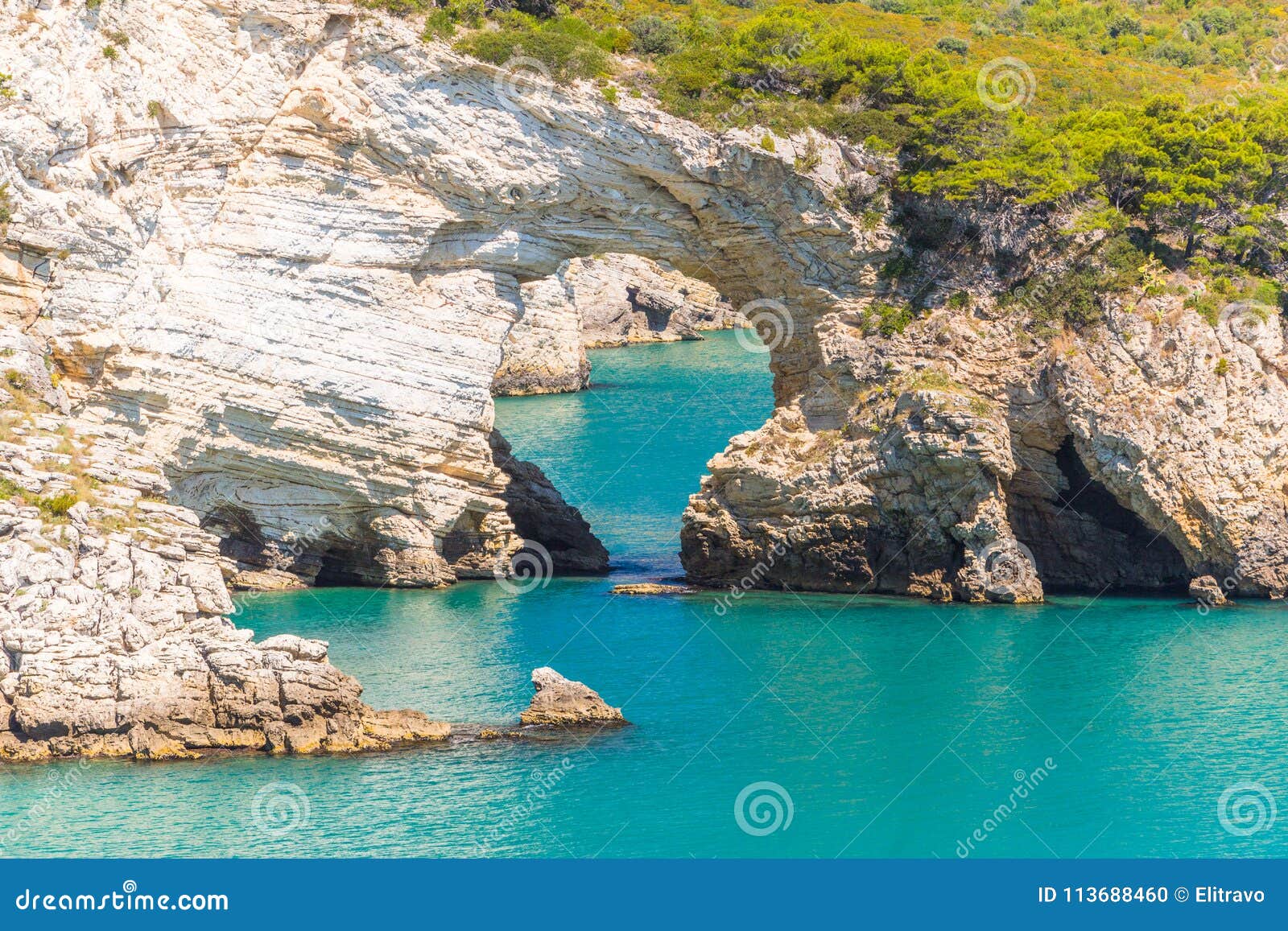 view of architello or san felice arch, on gargano coast, apulia, italy.