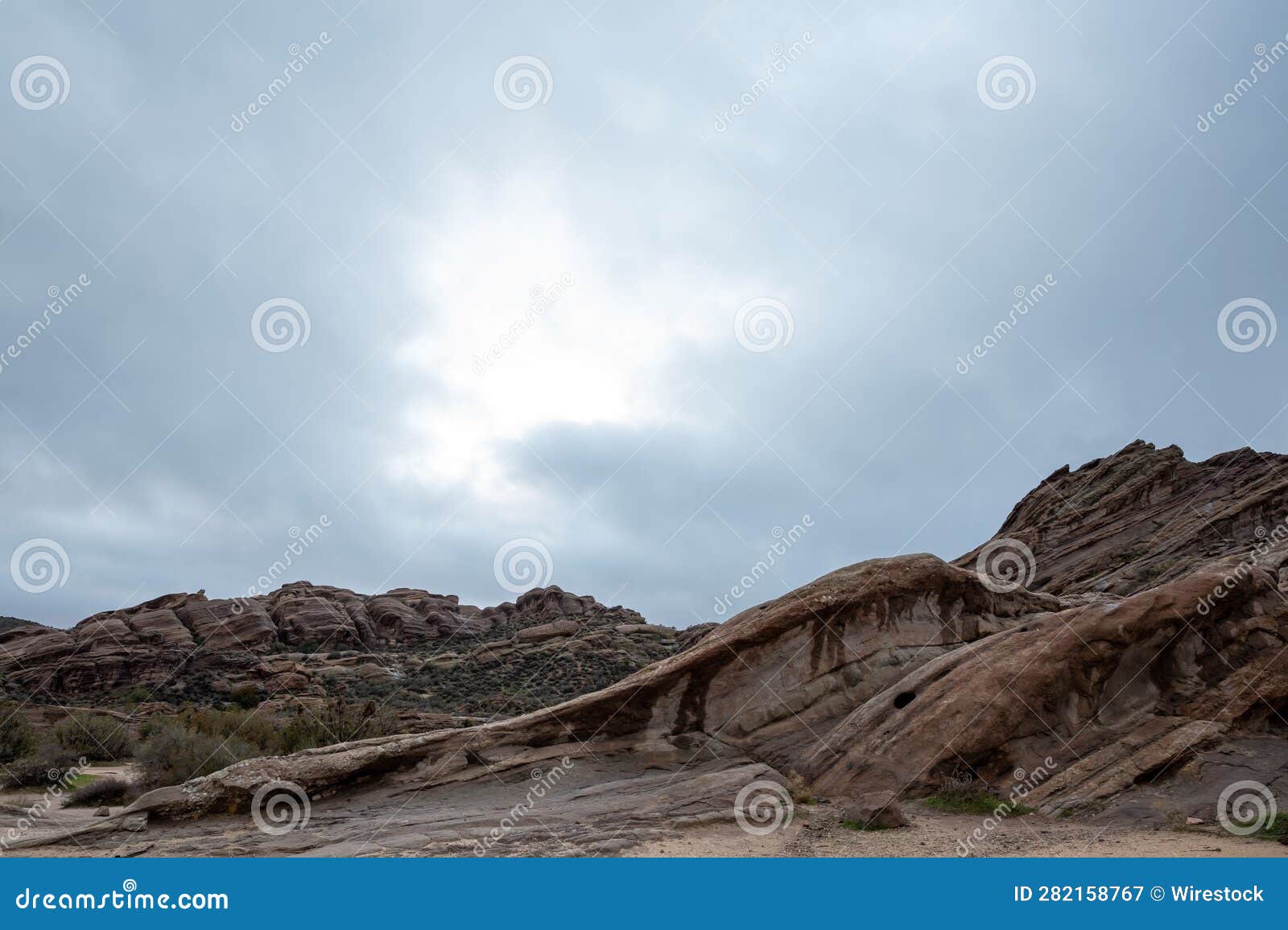 scenic view of vasquez rocks park in agua dulce, california against a clouded sky