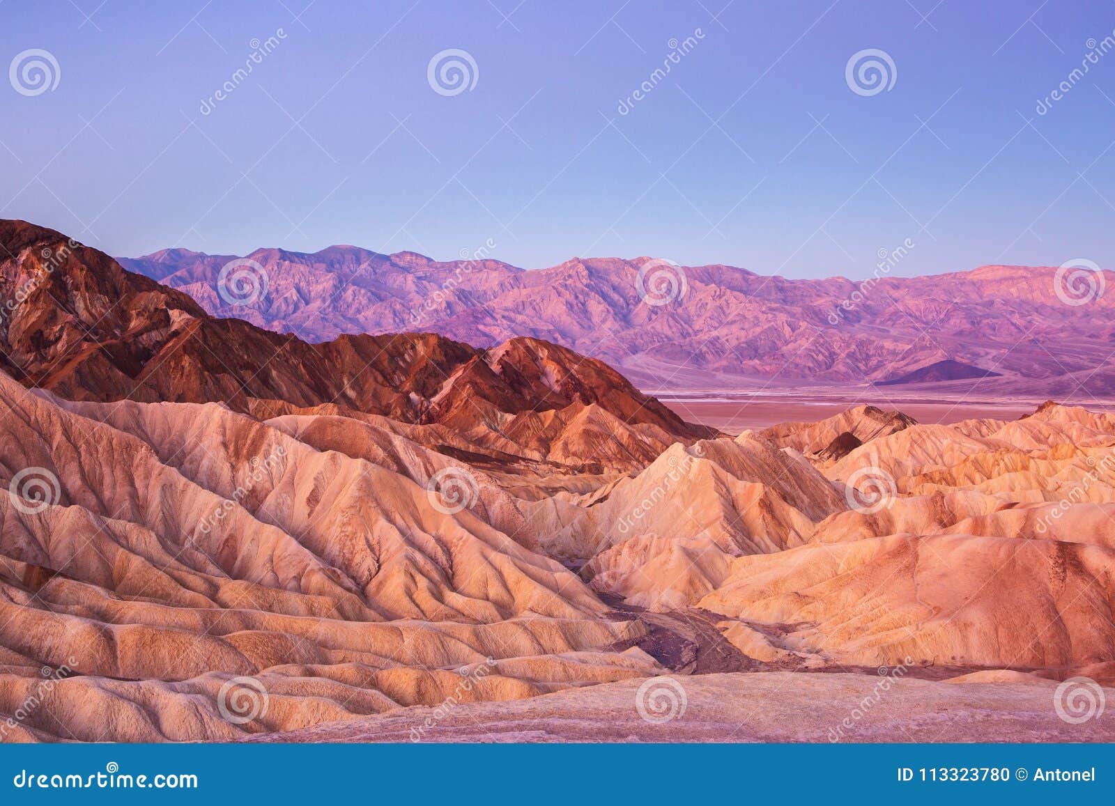 scenic view from zabriskie point, showing convolutions, color contrasts, and texture in the eroded rock at dawn, amargosa range,