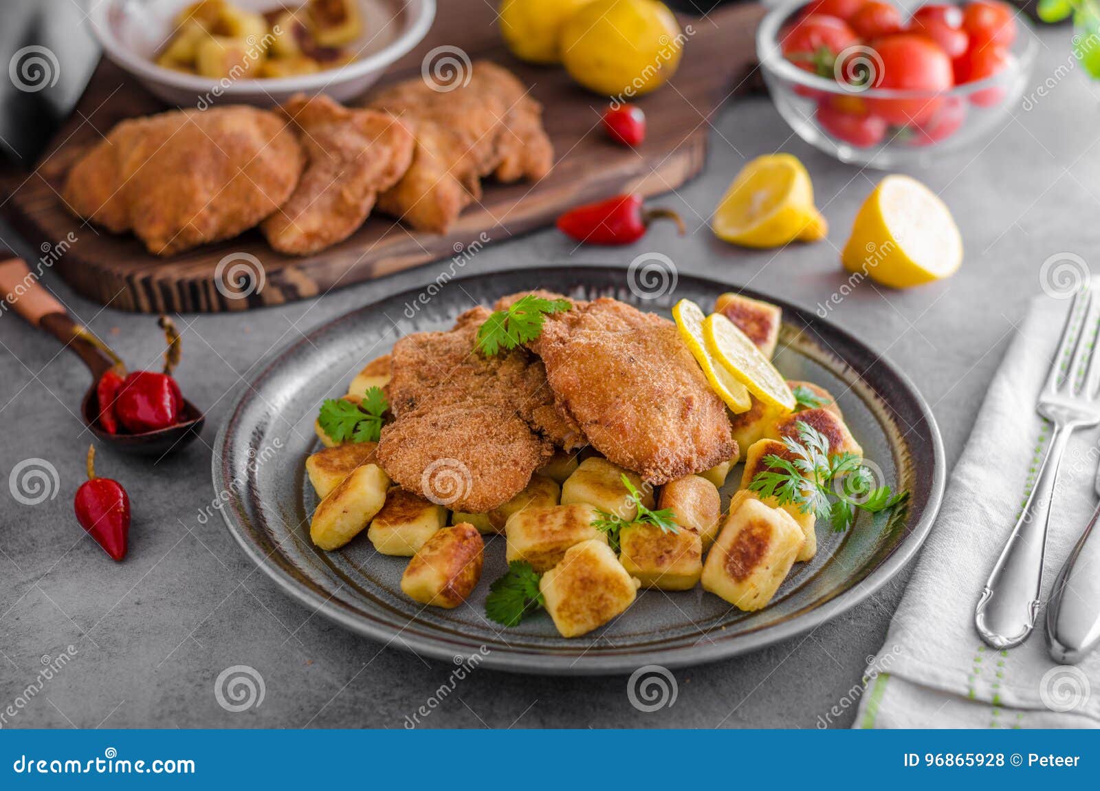 Schnitzel Original with Lemon and Gnocchi Fried Stock Photo - Image of ...