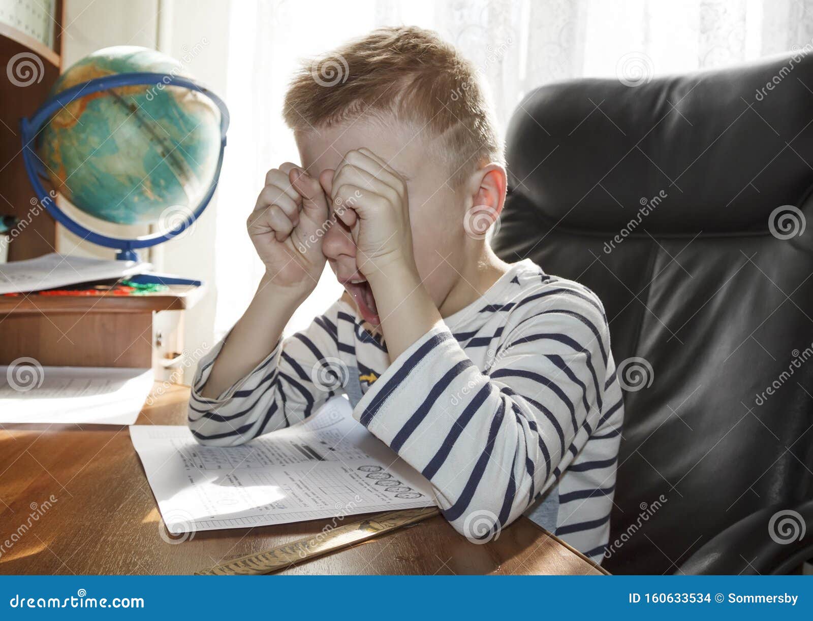 crying kid doing homework