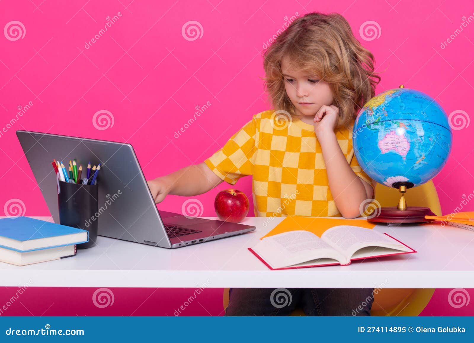 School Child Using Laptop Computer. School Child 78 Years Old with Book Go Back To School