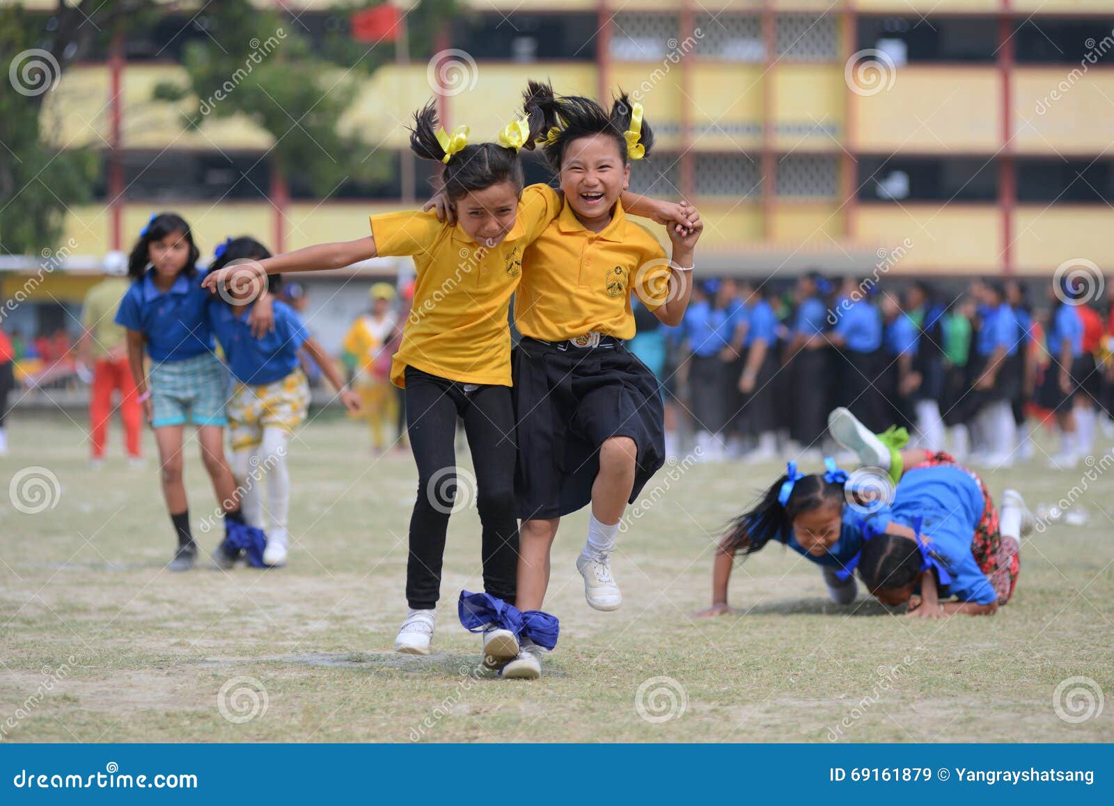 school children compete in three legged race