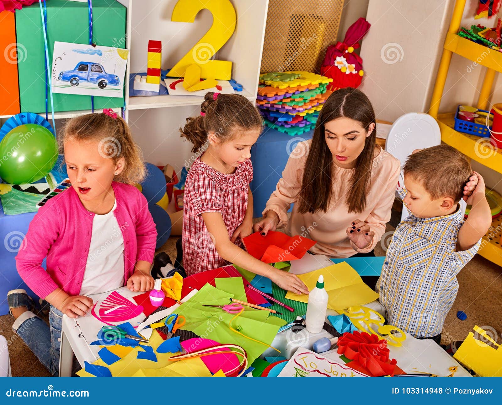 School Children With Scissors In Kids Hands Cutting Paper. Stock Photo 