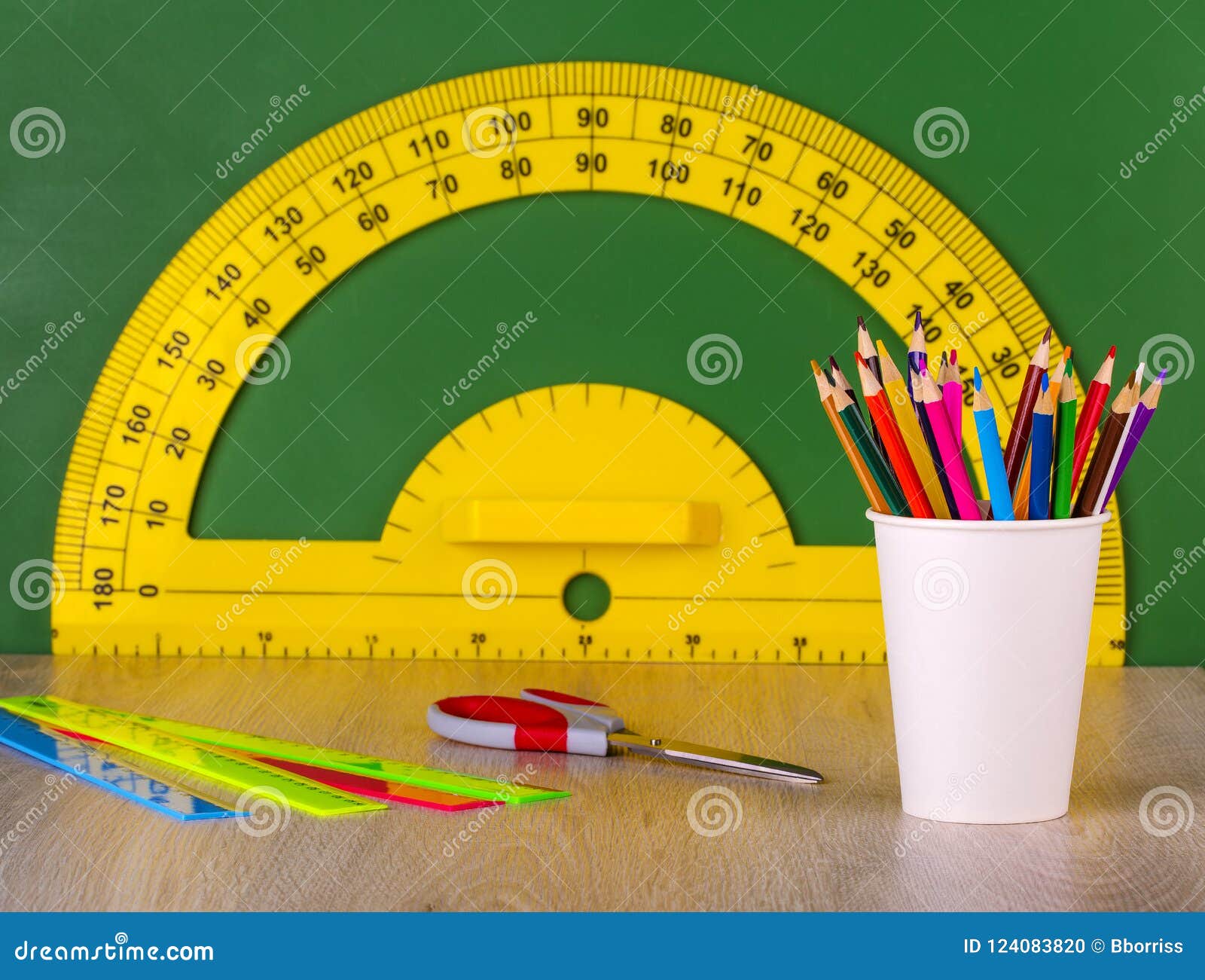 school concept colore pencil, ruler, scissors and yellow protractor