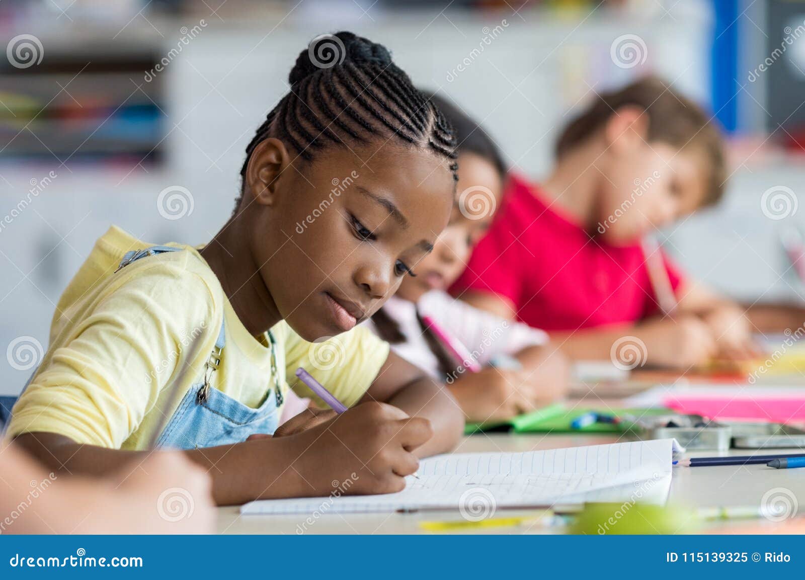 school girl writing in class