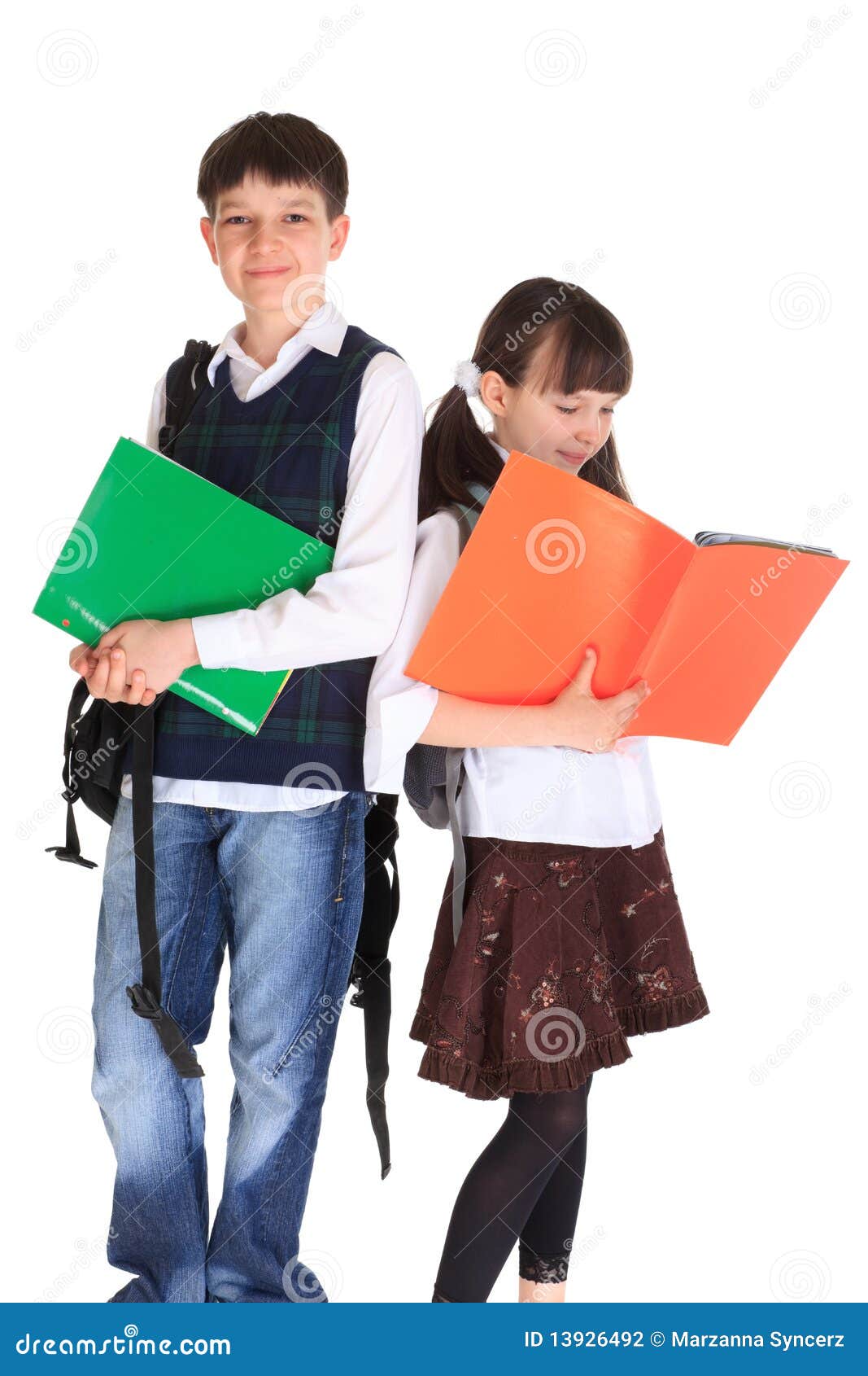 School Going Siblings. Cute siblings going to a school holding their notes, isolated on white studio background.