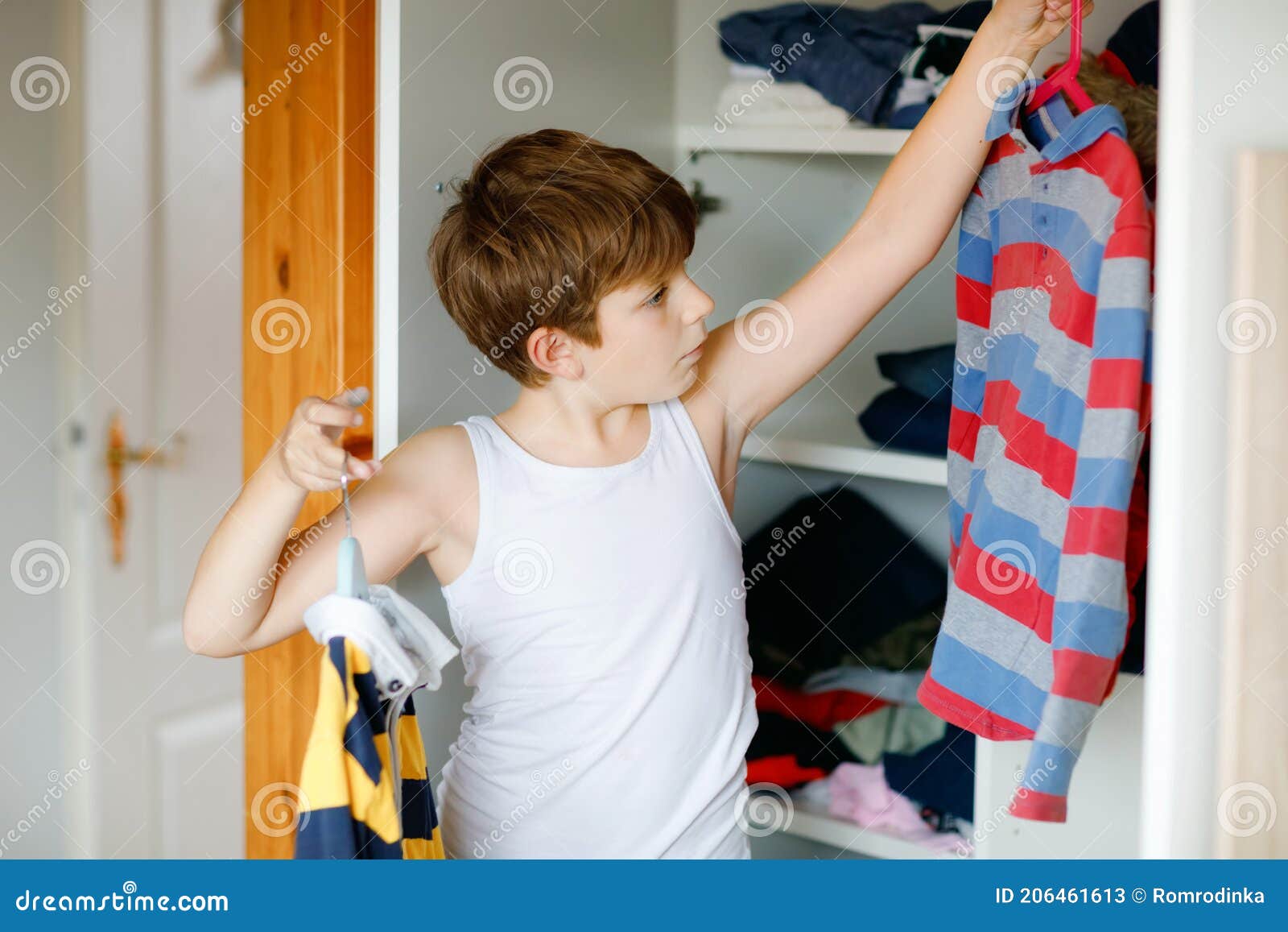 School Kid Boy Standing by Wardrobe with Clothes. Child Making Decision ...