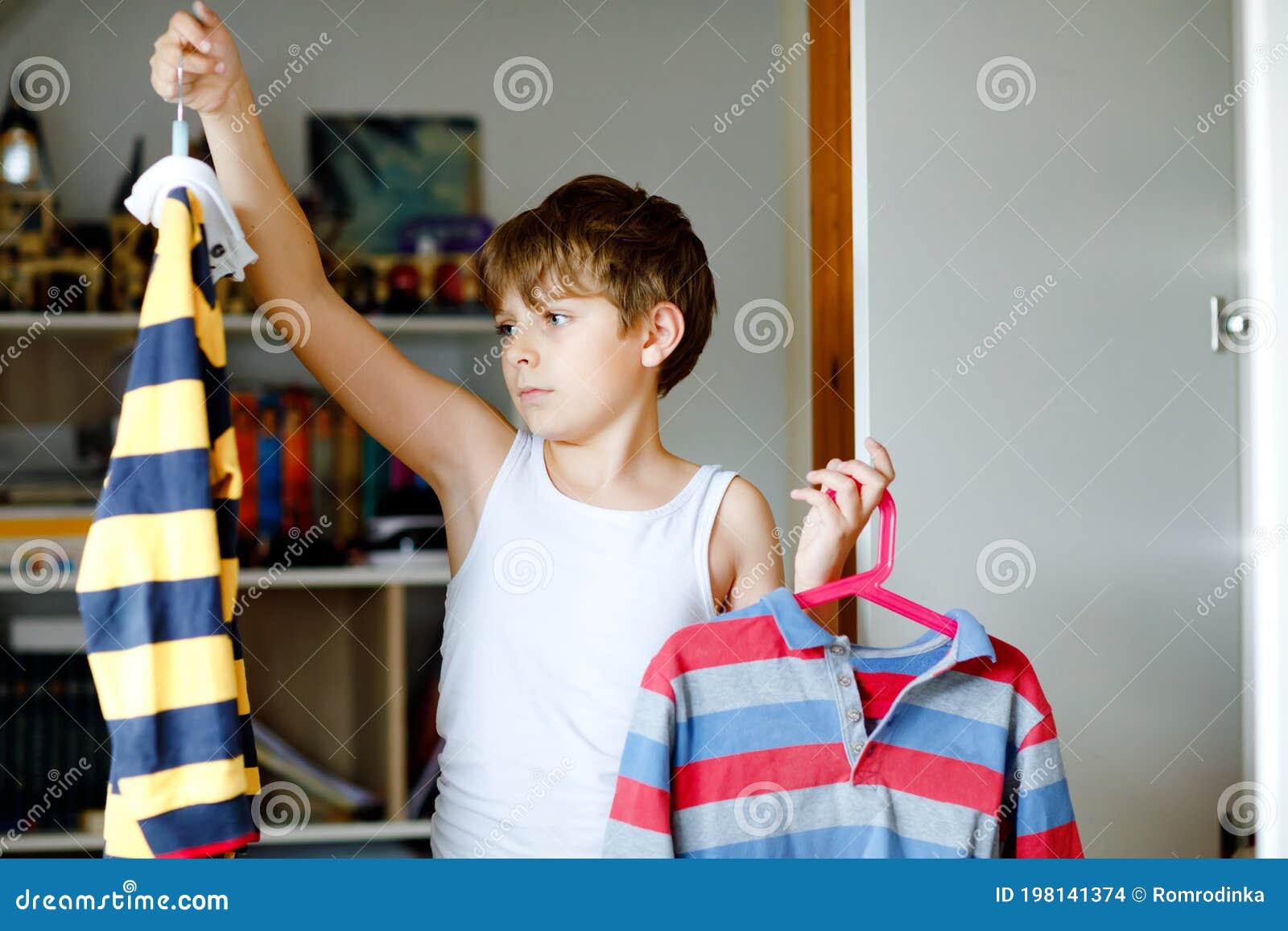 School Kid Boy Standing by Wardrobe with Clothes. Child Making Decision ...