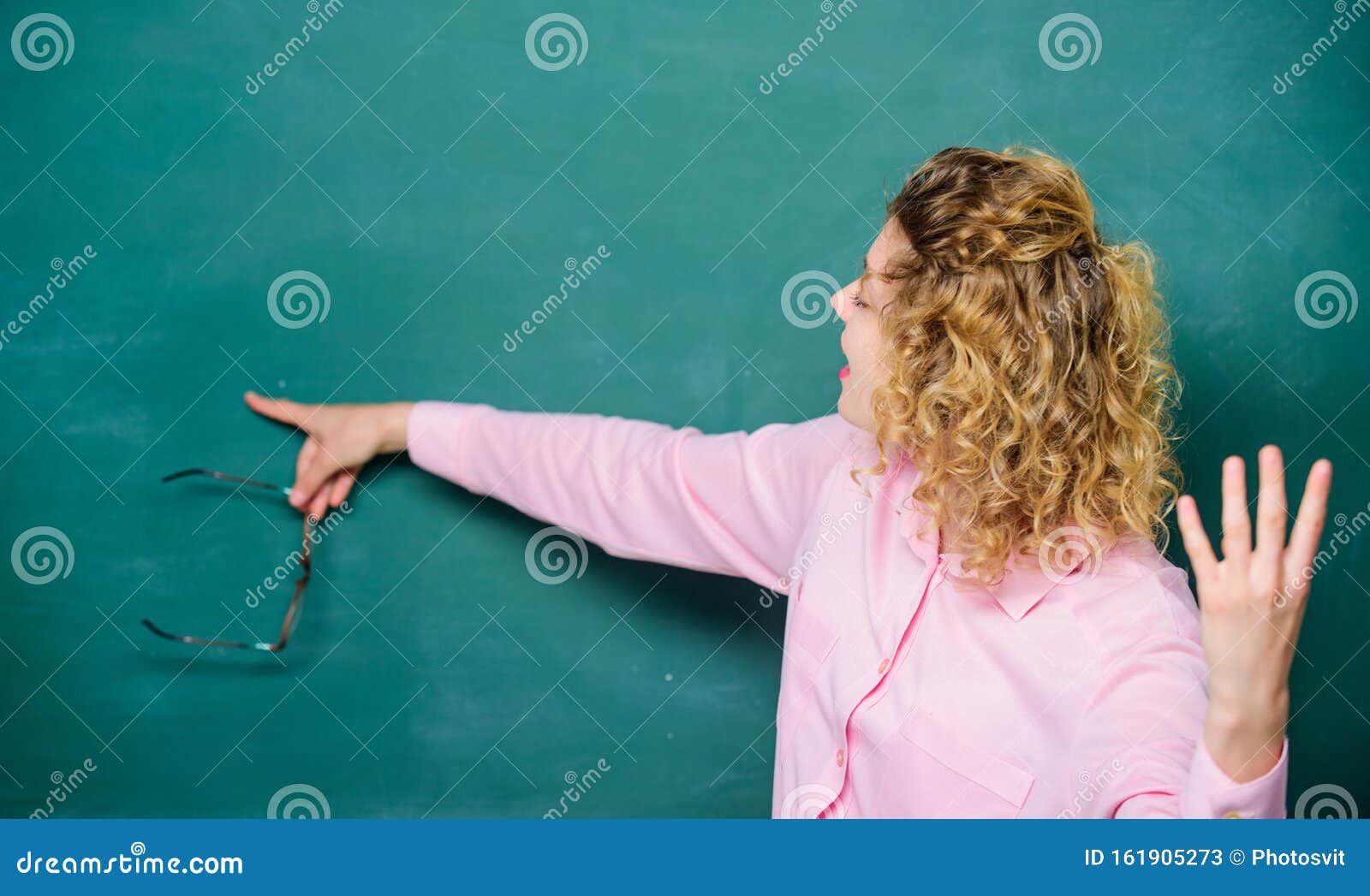 school lesson knowledge. remember this. strict woman teacher pointing at chalkboard. informing kids. school rules