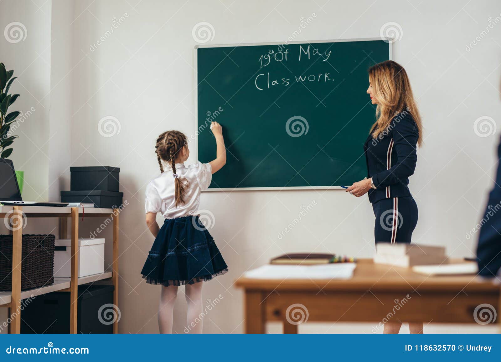 School Lesson Teacher And Pupil Write On A Blackboard Stock Photo