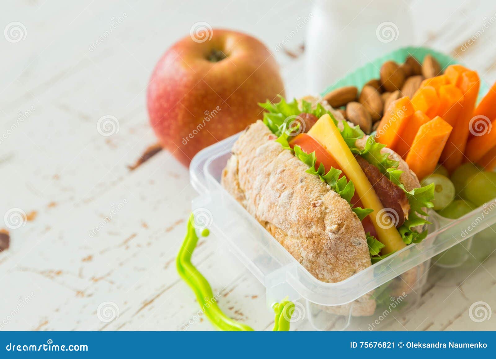 School Lunch Box with Books and Pencils in Front of Black Board Stock