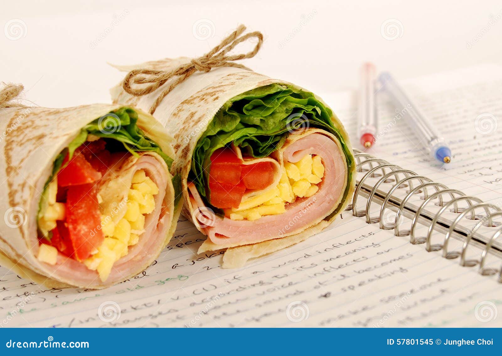 School Lunch Ham and Cheese Wrap Sandwich on Notebook Stock Image