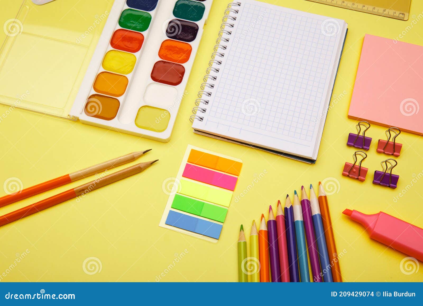 School Notebook and Various Stationery on Yellow Background. Back To