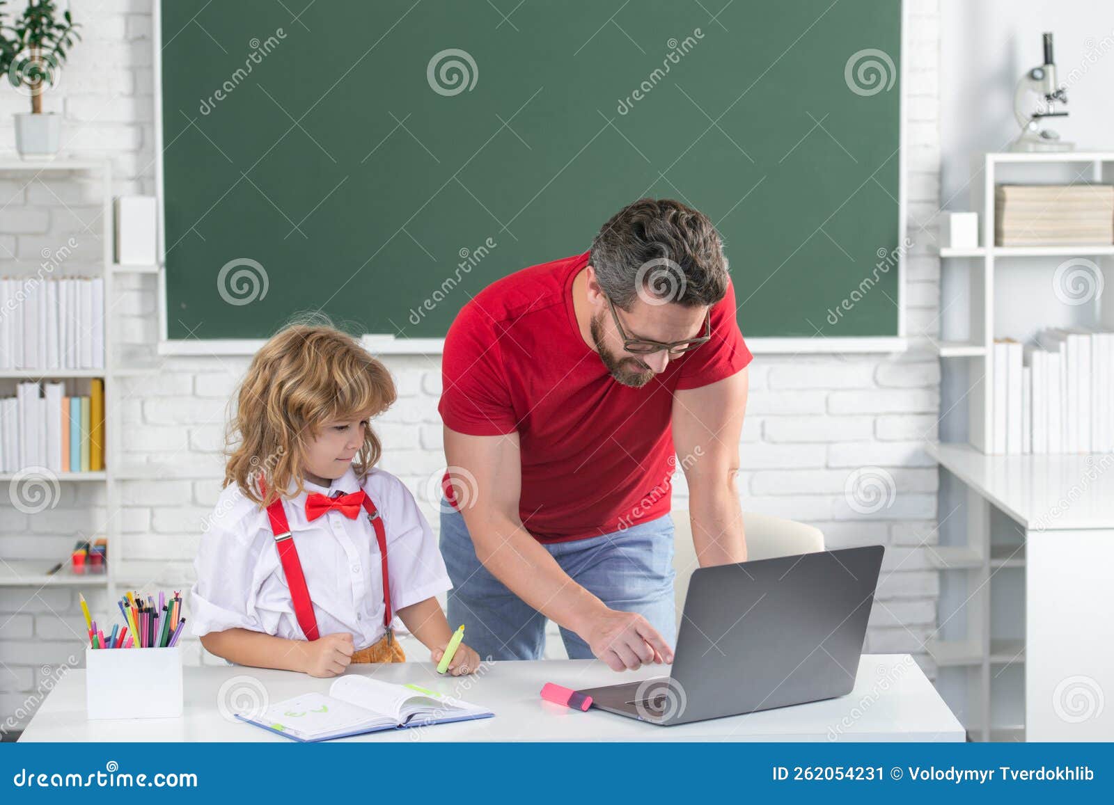 School Teacher with a Schoolboy Learning at Laptop Computer, Studying