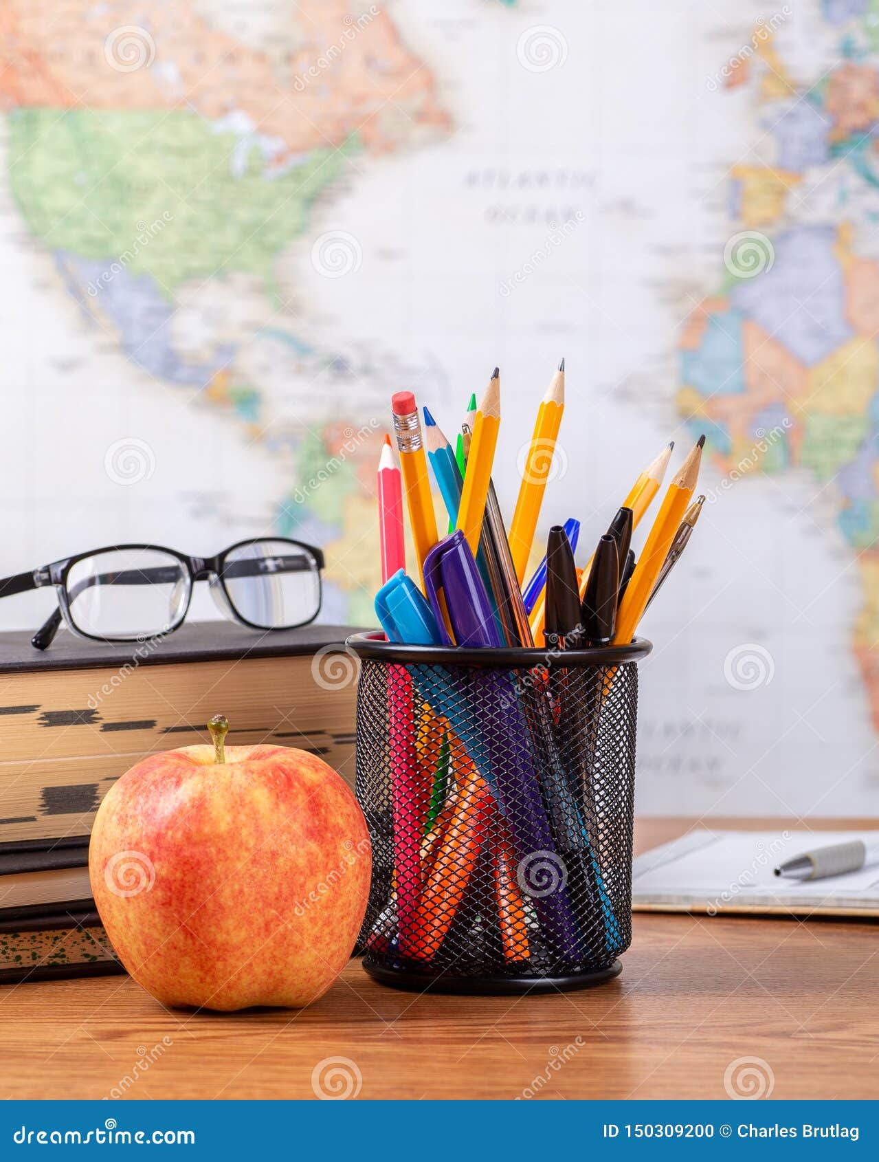 School Teachers Desk With World Map In Background Stock Photo