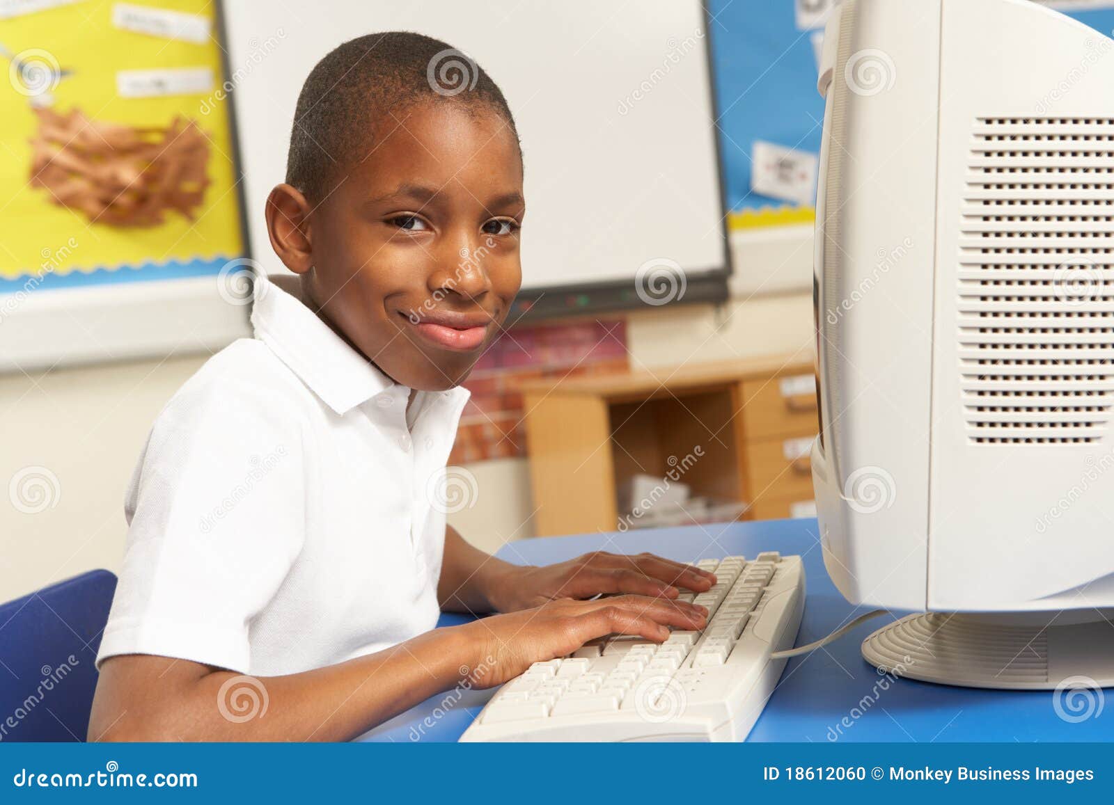 schoolboy in it class using computer