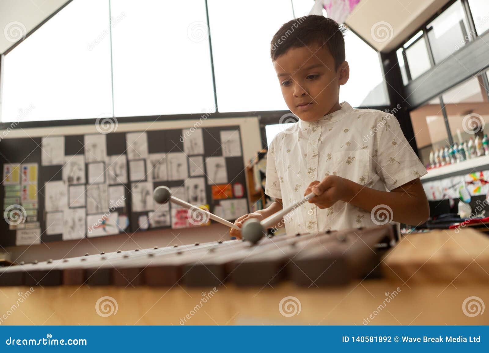 Schoolboy Playing Xylophone in a Classroom Stock Photo Image of