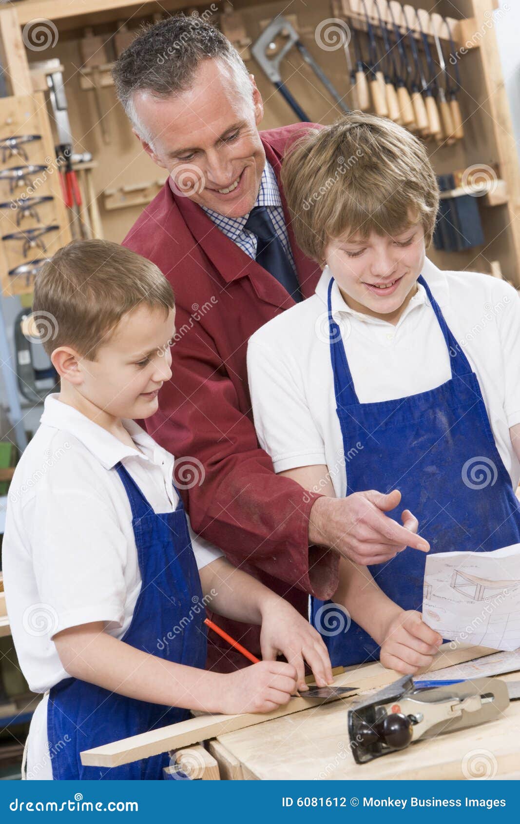 schoolboys and teacher in woodwork class