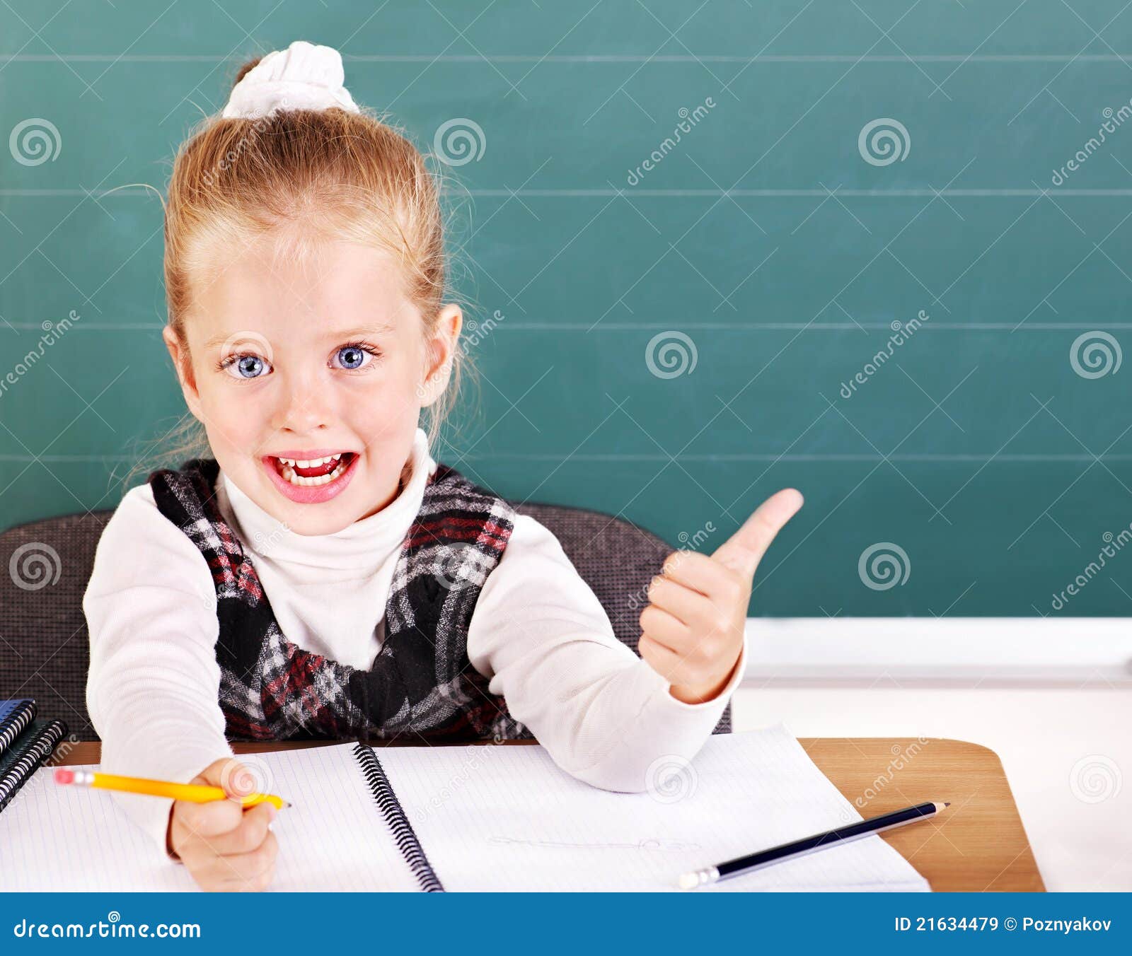 schoolchild in classroom near blackboard.