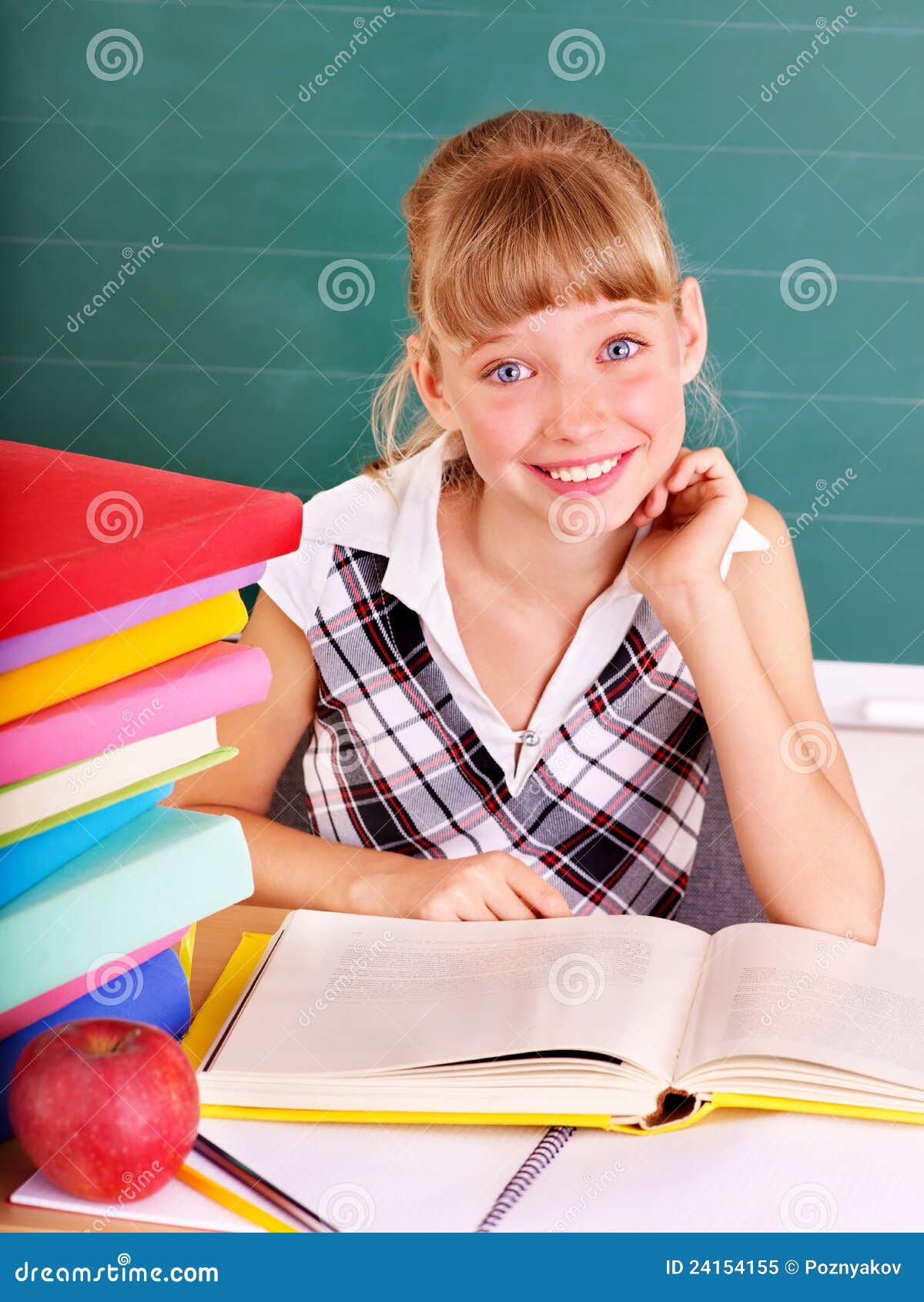 schoolchild in classroom near blackboard.