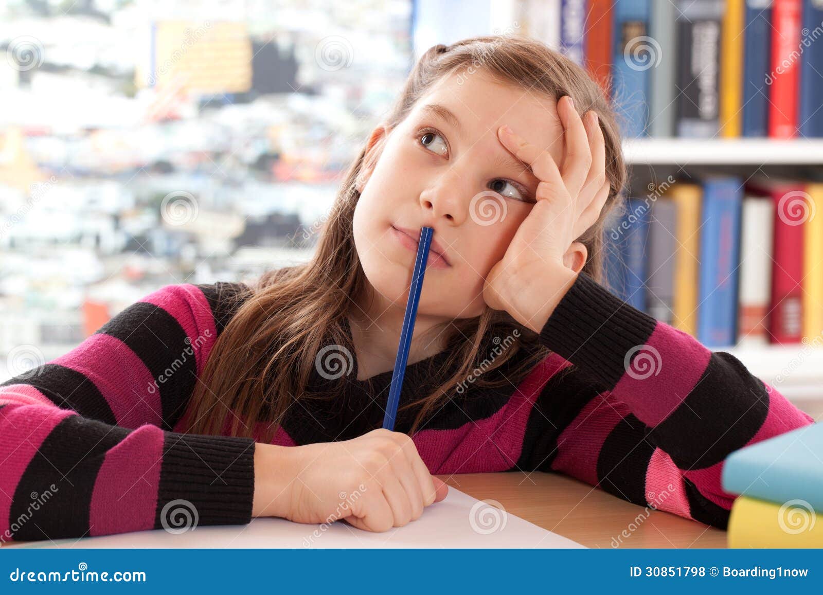 schoolchild thinking while doing homework