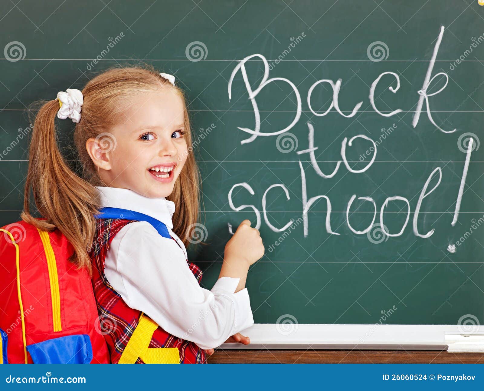 schoolchild writting on blackboard.