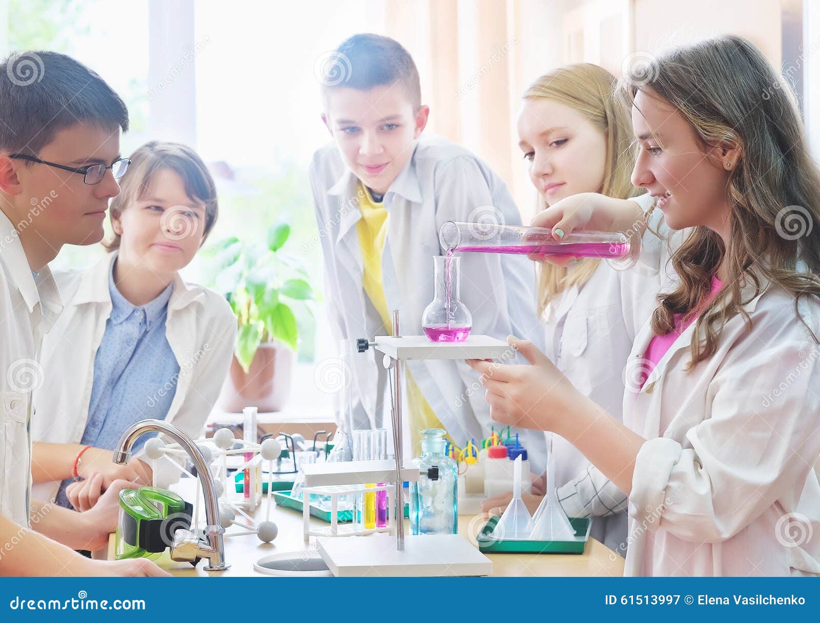 schoolchildren doing experiment in science class