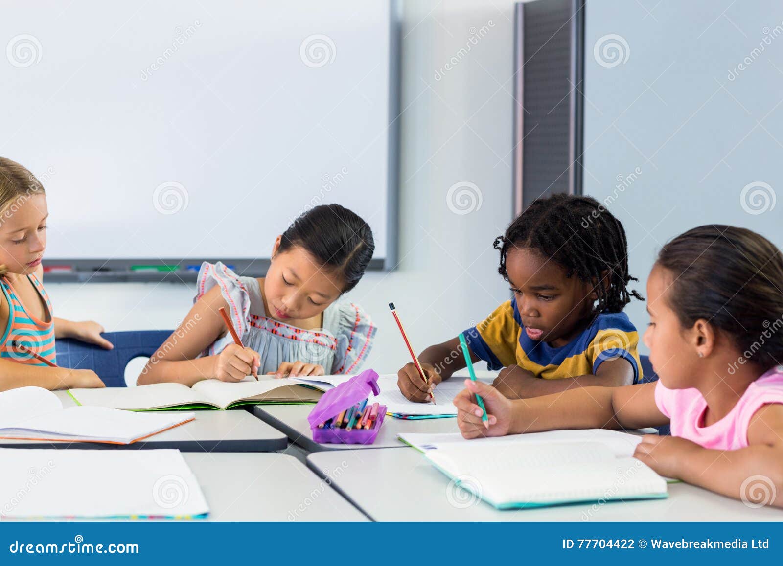 schoolchildren writing on books