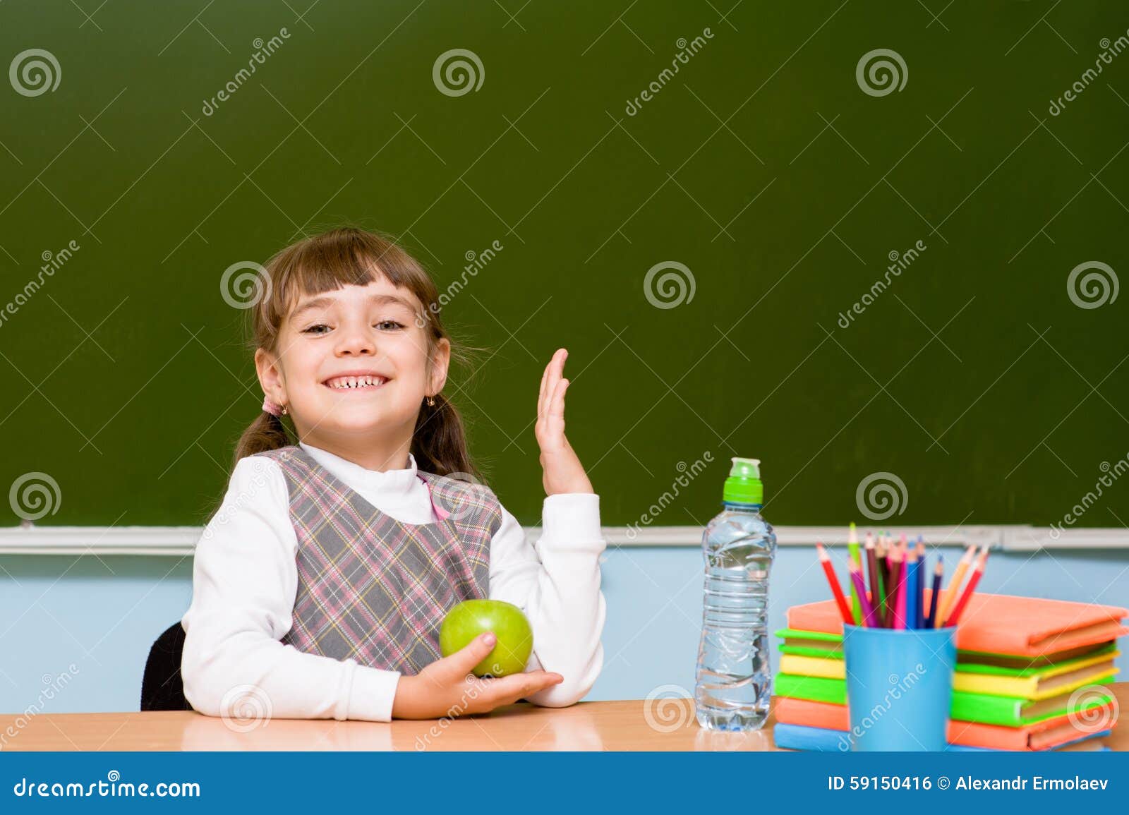 schoolgirl ary school raising hands knowing the answer to question