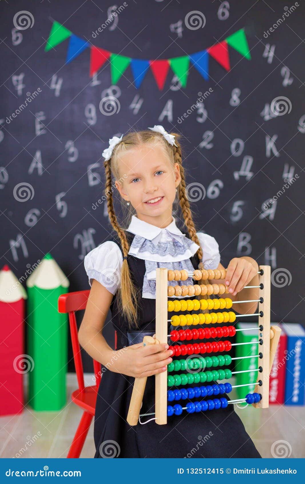 the schoolgirl in school uniform with books and textbooks is on a light gray background. back to school. the new school year.