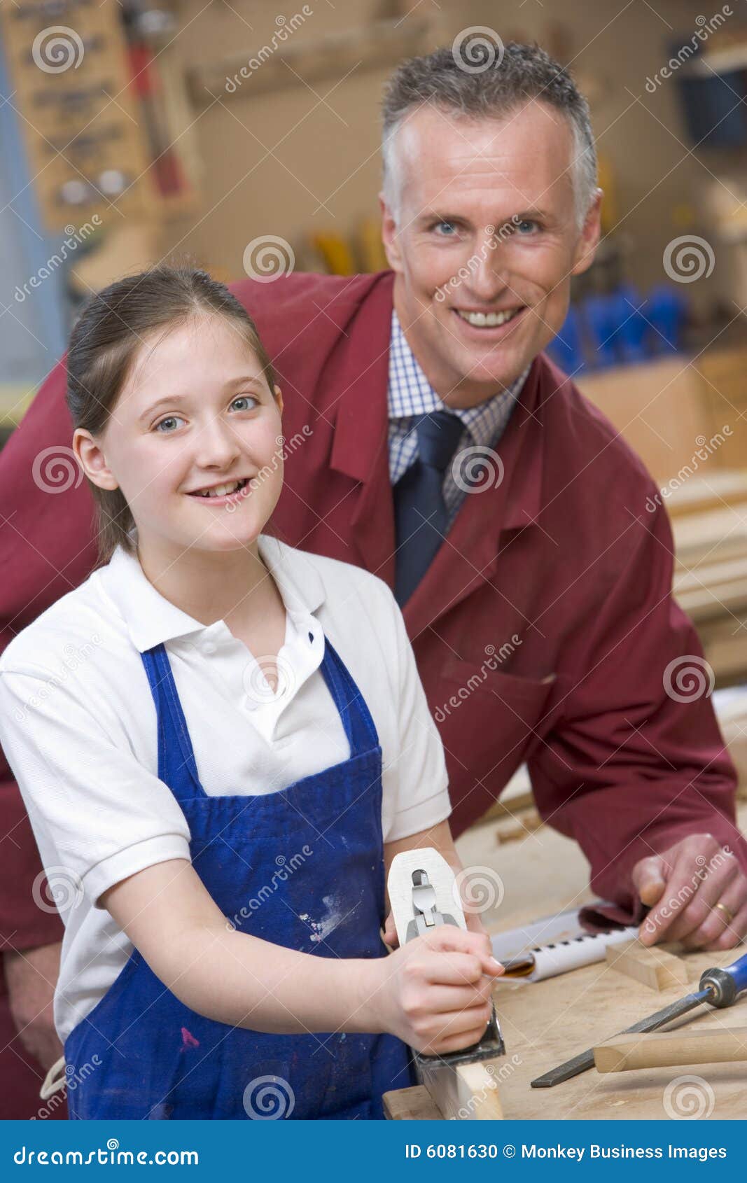 schoolgirl and teacher in woodwork class