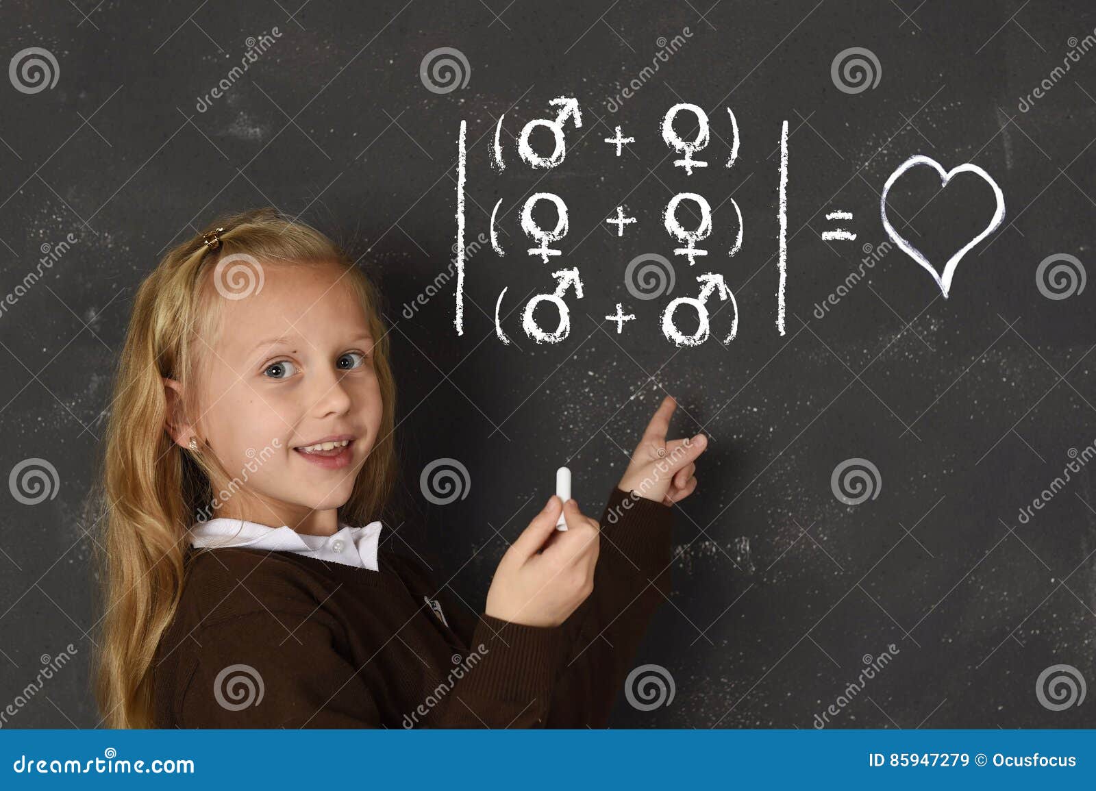 schoolgirl in uniform holding chalk writing on blackboard standing for freedom of sexuality orientation