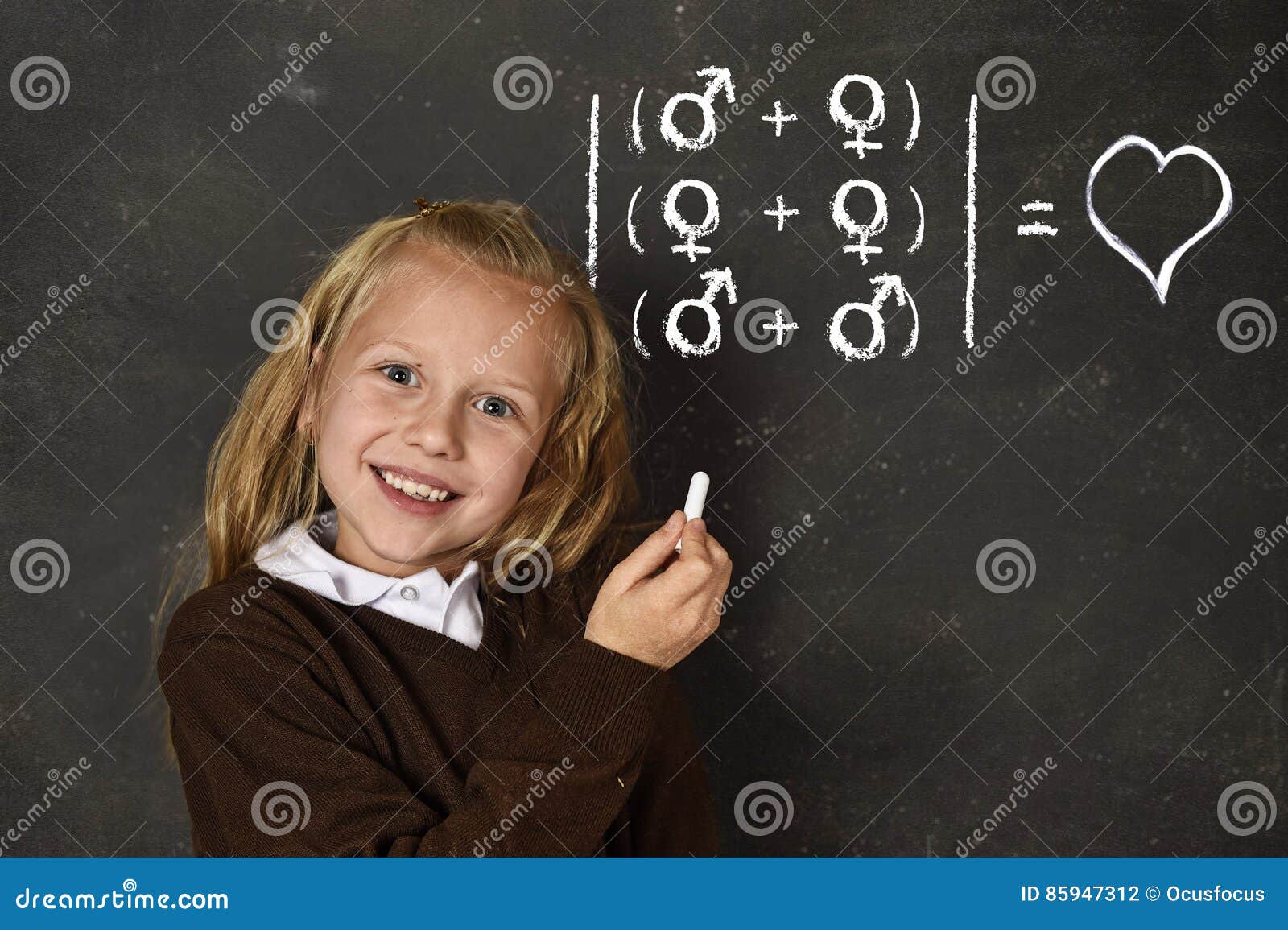 schoolgirl in uniform holding chalk writing on blackboard standing for freedom of sexuality orientation