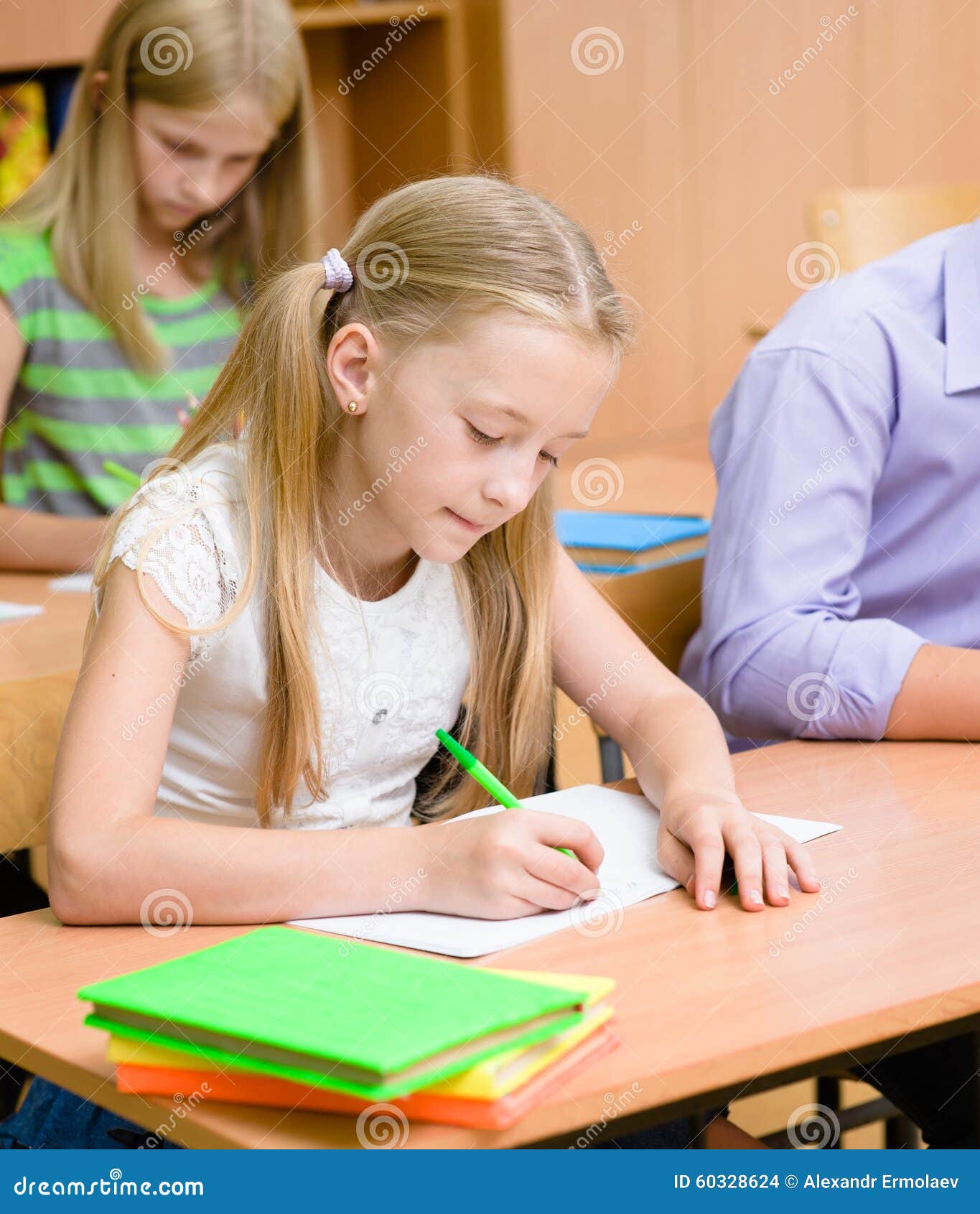 schoolgirl writes the exam in class