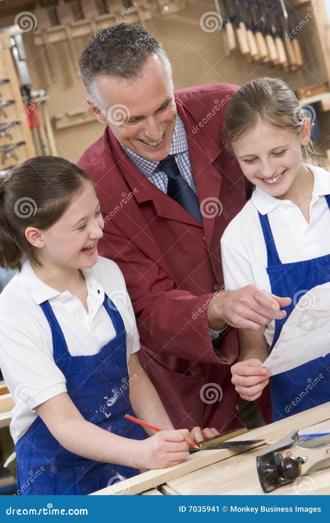 schoolgirls and teacher in woodwork class