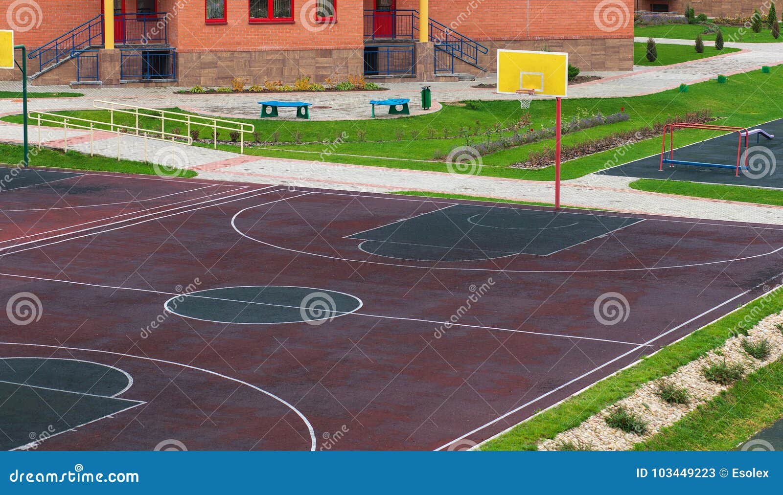 schoolyard with a playground for basketball.