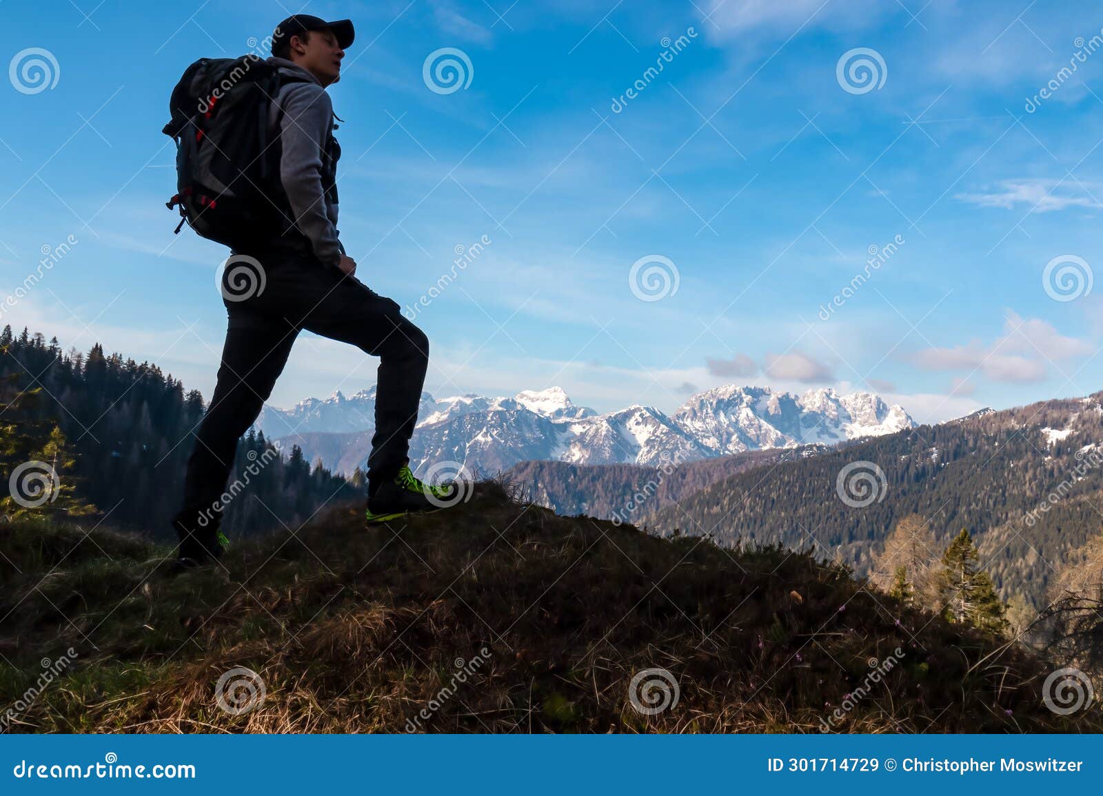 schwarzkogel - hiker man with scenic view of snow covered mountain range julian alps seen from karawanks